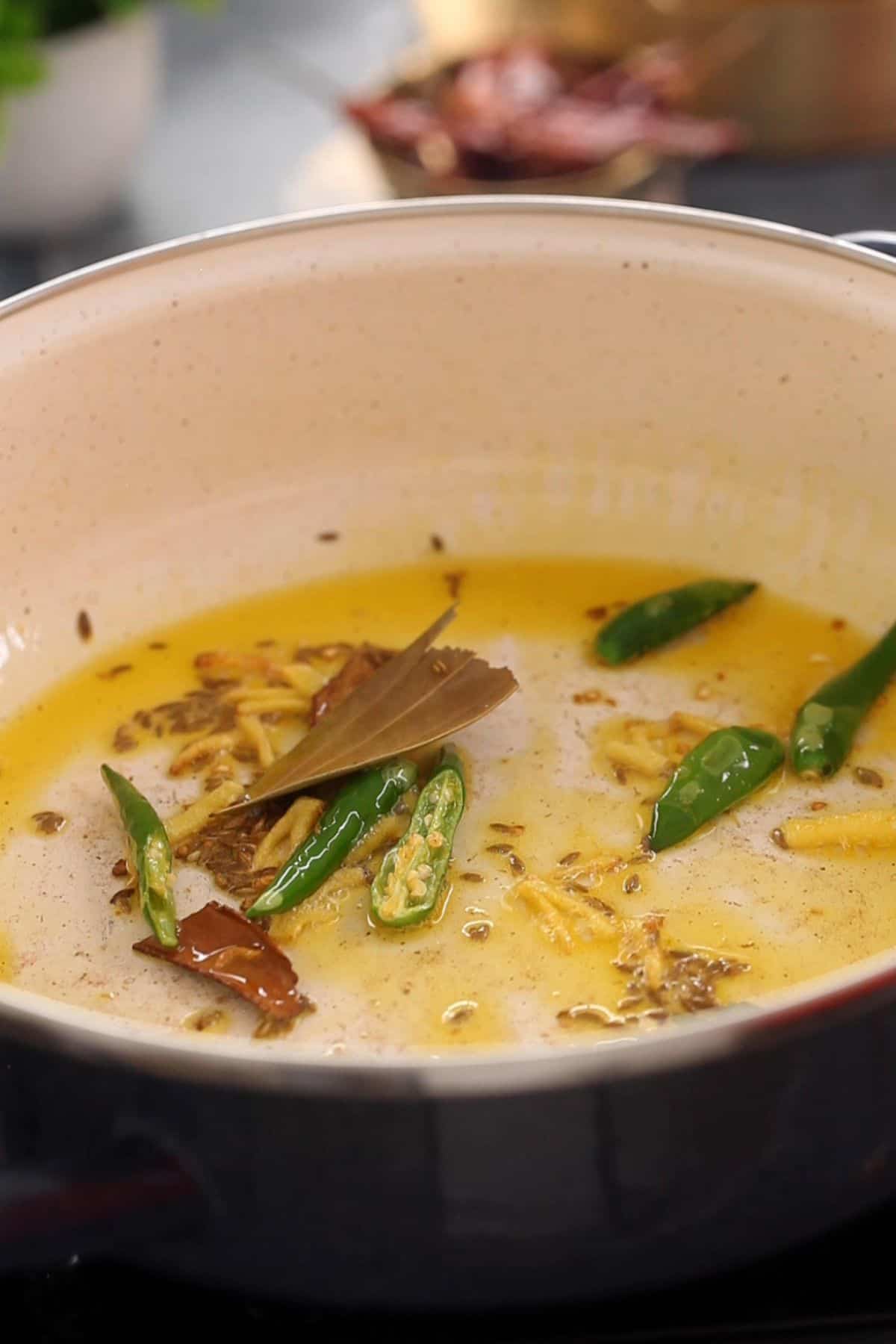 Tempering mustard oil with whole spices. 