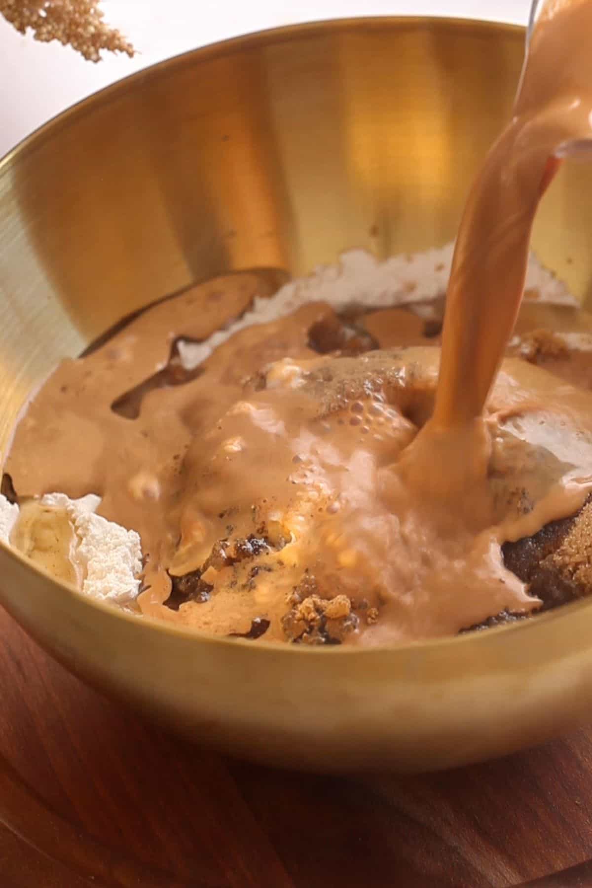 Wet ingredients are poured over dry ingredients.