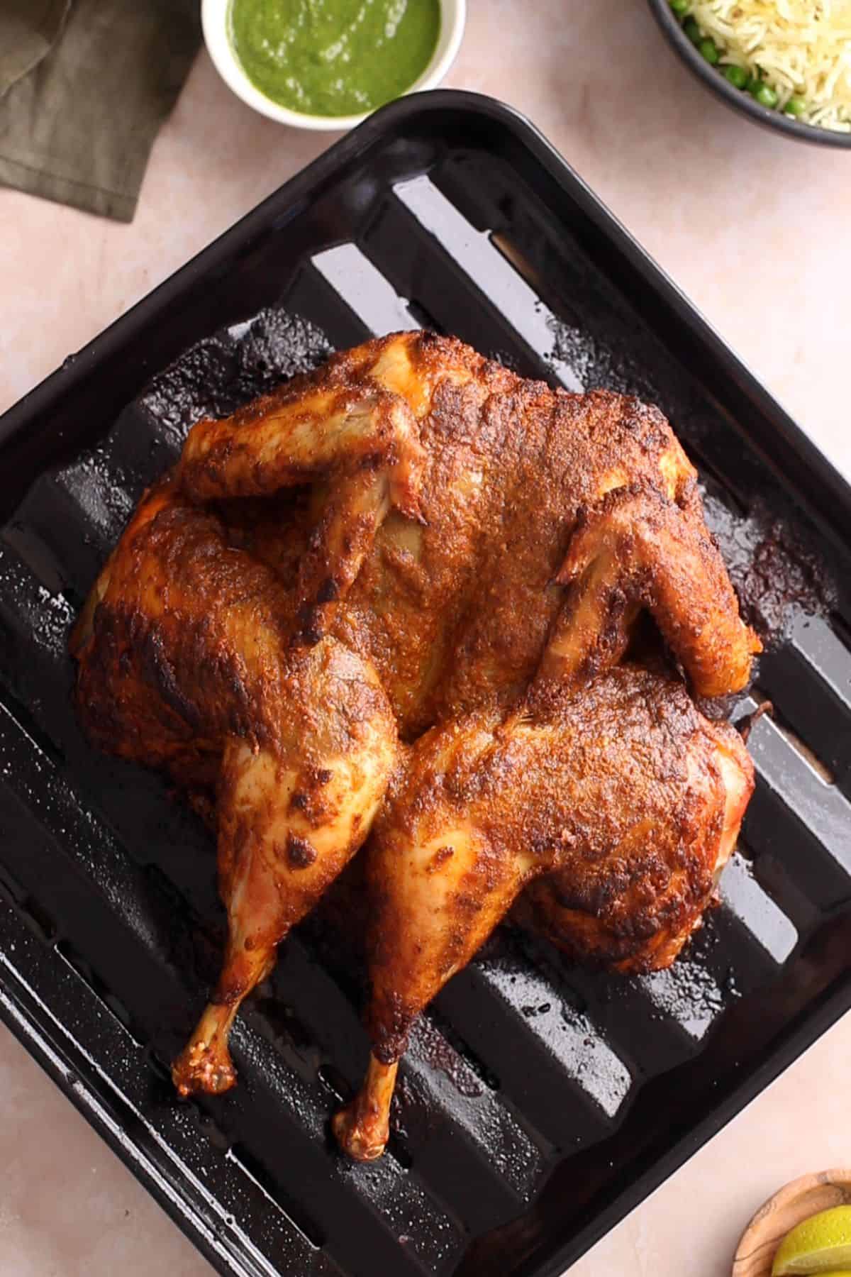 Indian spiced roasted whole chicken is ready to carve.