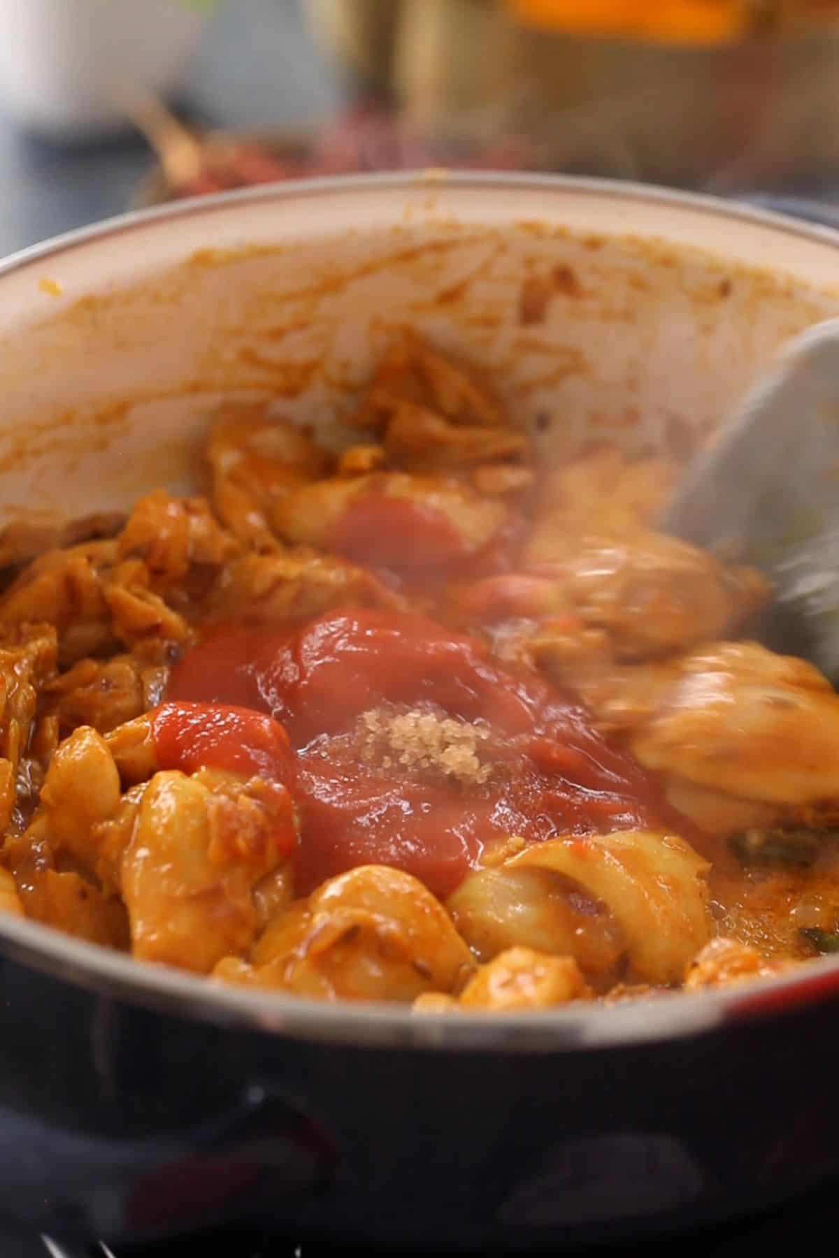 Tomato purée is added to kadai chicken.