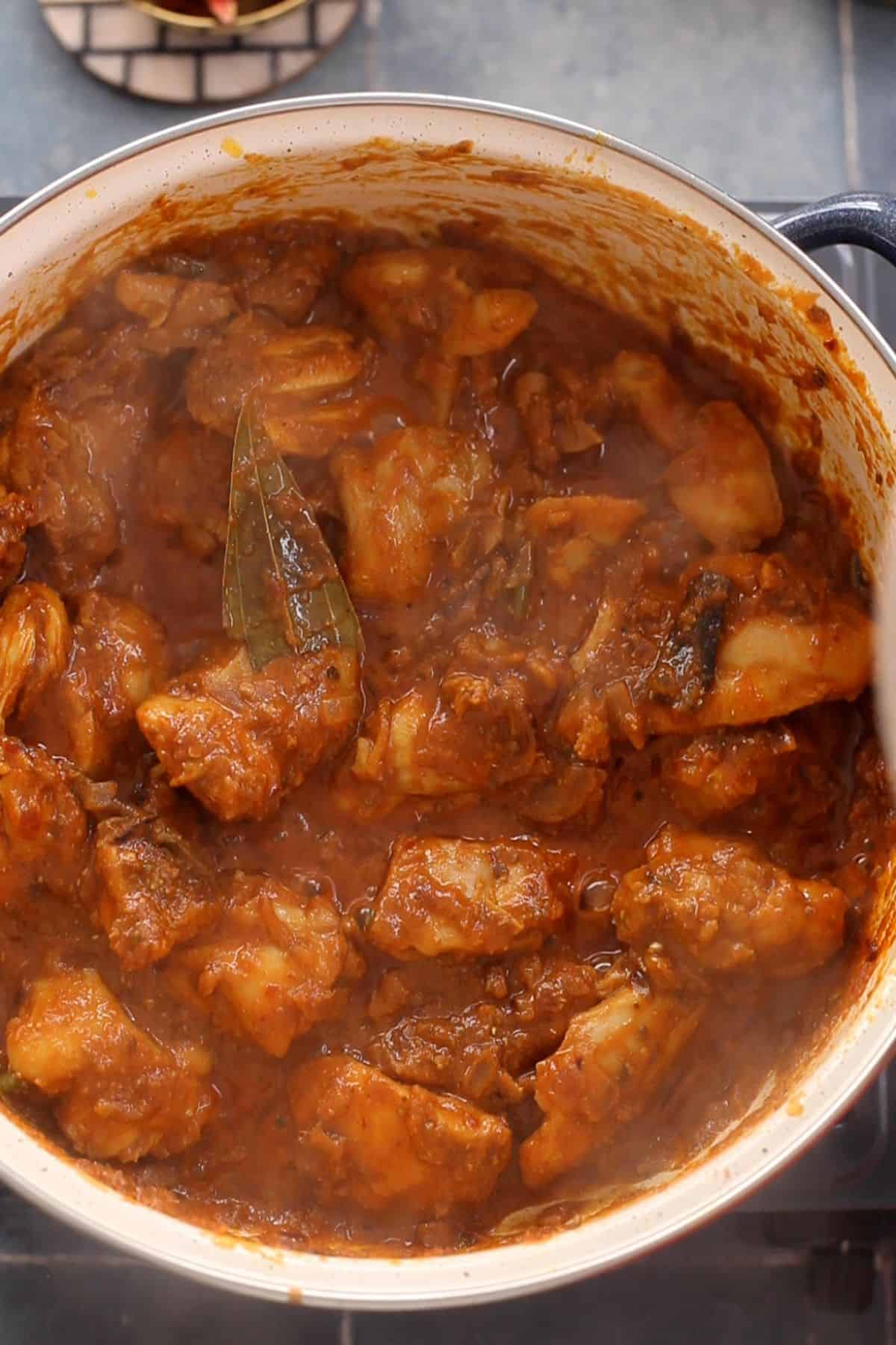 Kadai chicken is stir fried with spices and tomato.