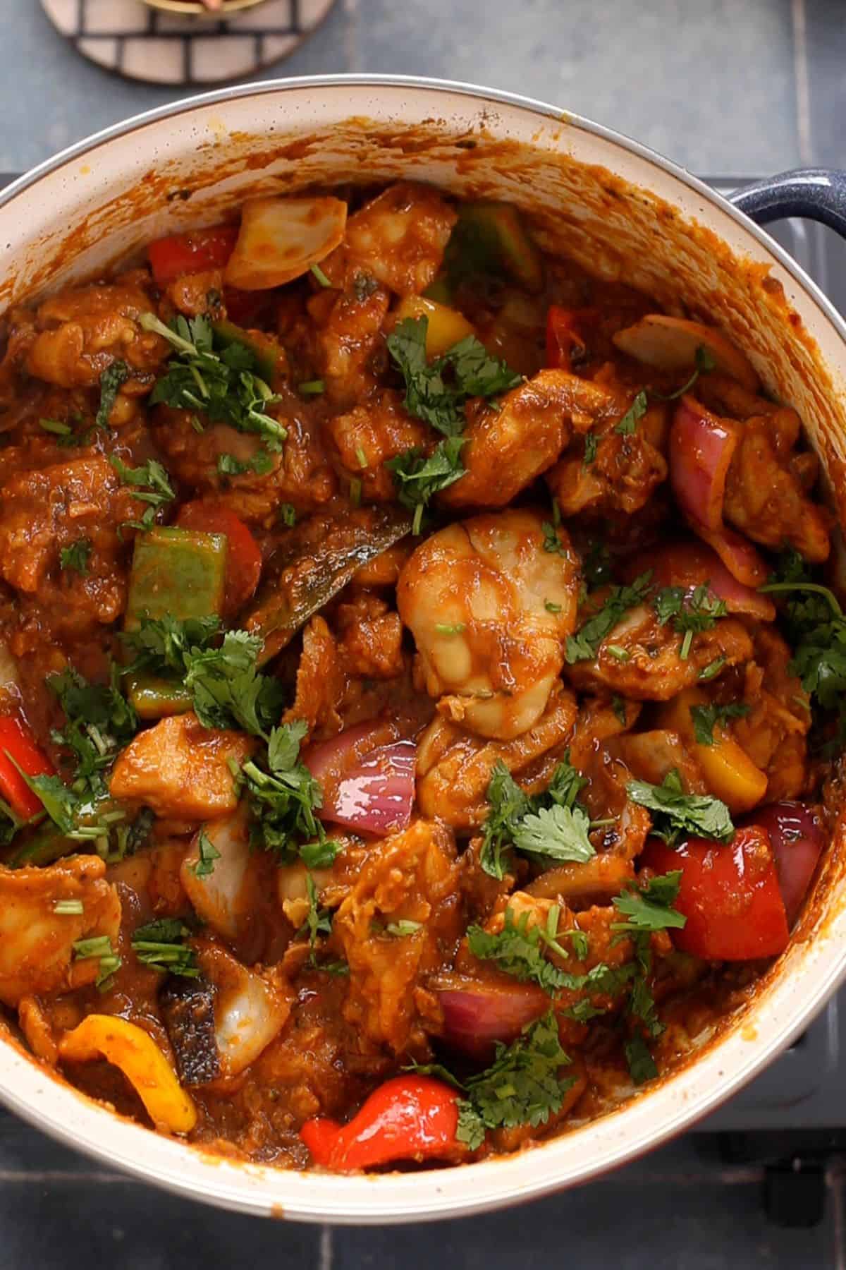 Kadai chicken is garnished with cilantro and is ready to serve.