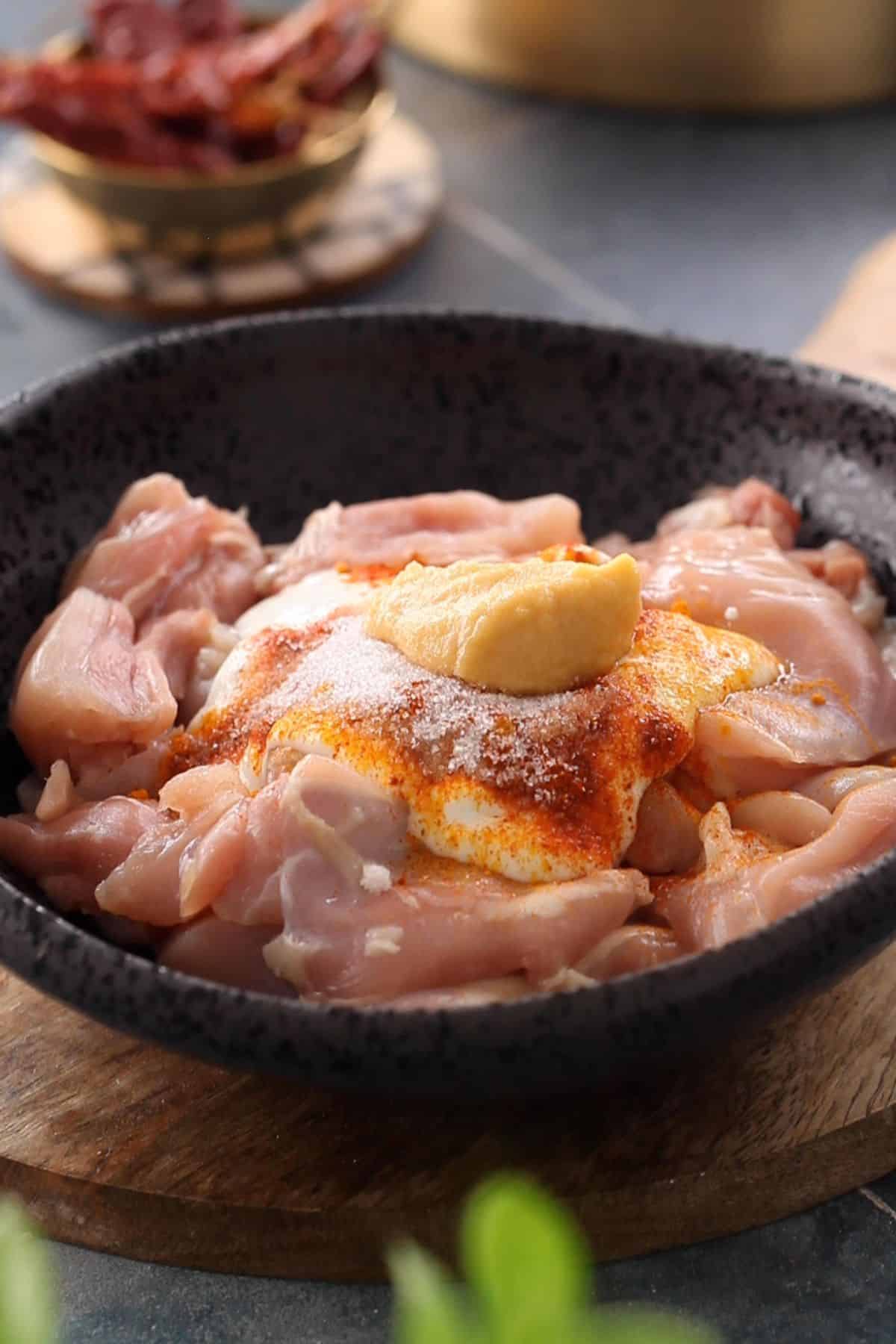Raw chicken to which yogurt spices, salt and ginger garlic paste are added. 