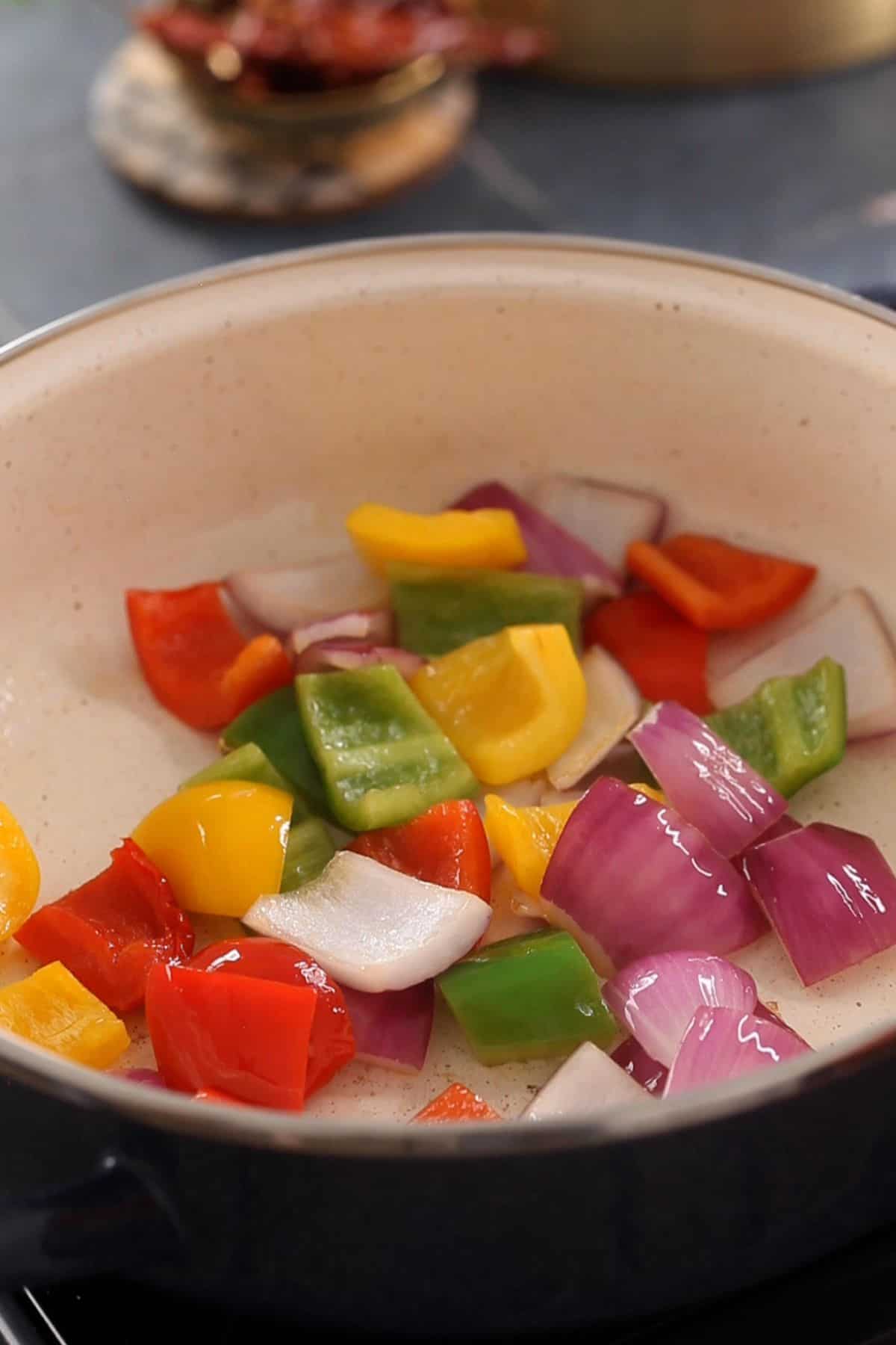 Onions and peppers are stir fried until lighty charred.
