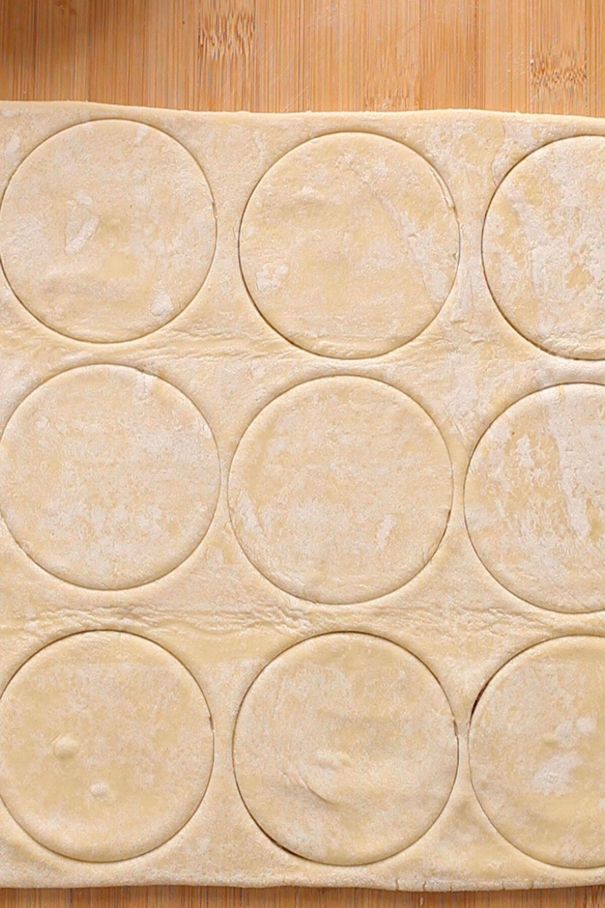 Puff pastry sheet cut in round shape.