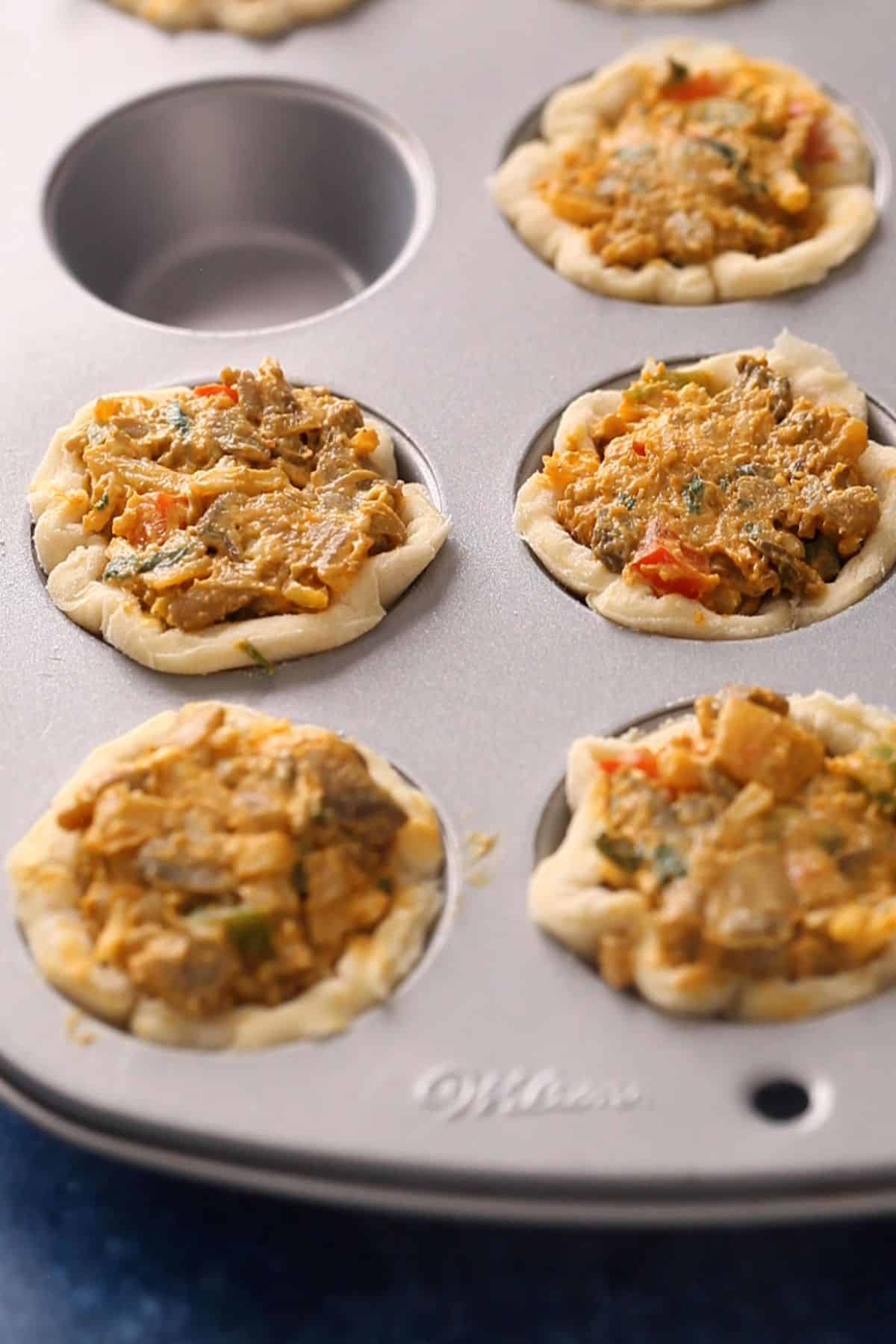 Mushroom filling is stuffed into tart shell.