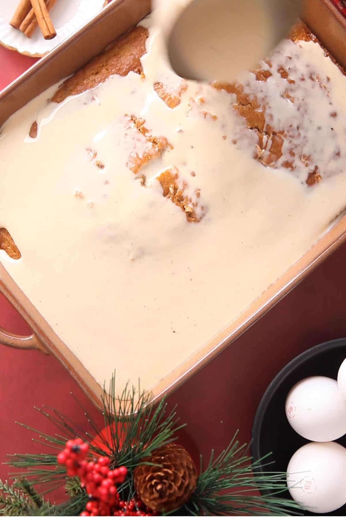 Pouring the tres leche mixture over the baked cake.