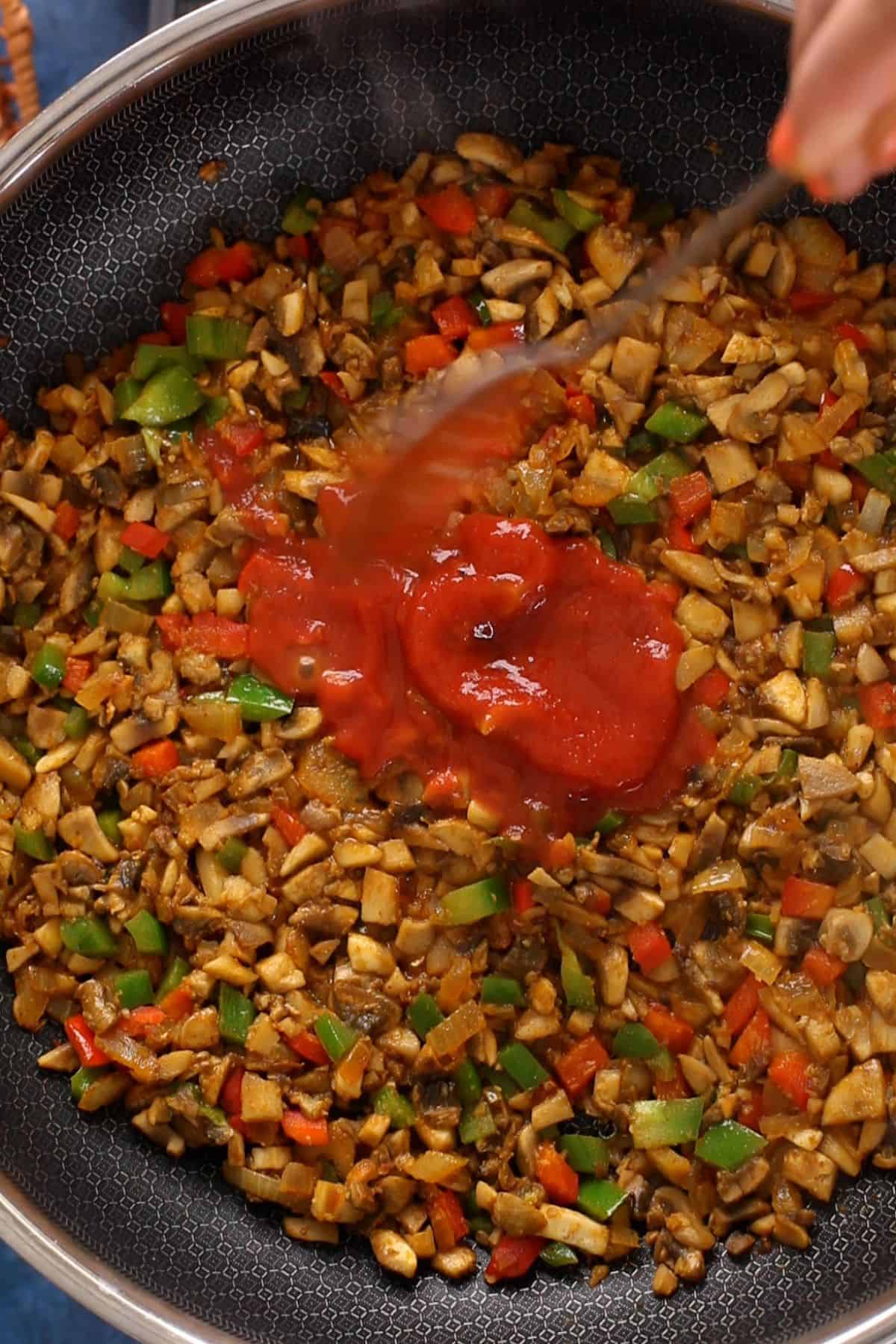 Tomato sauce is added to mushroom masala.