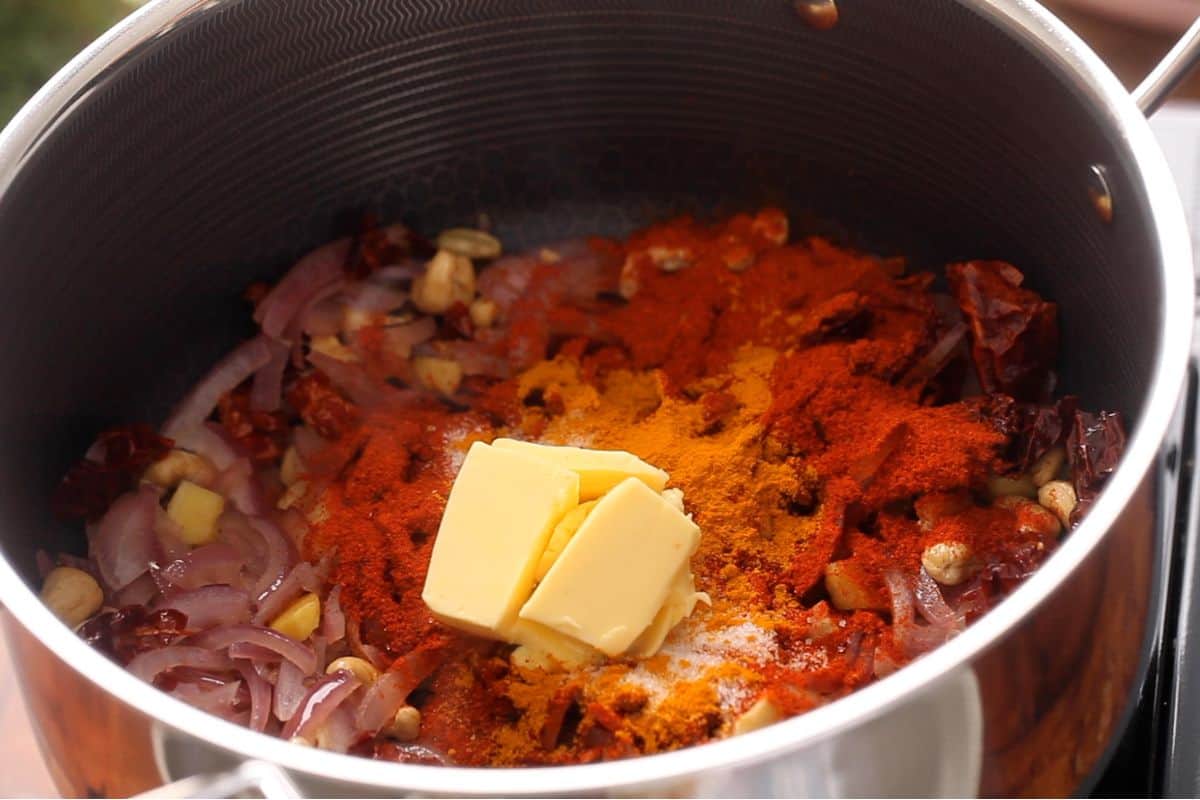 Butter and powdered spices are added to coooking pot.