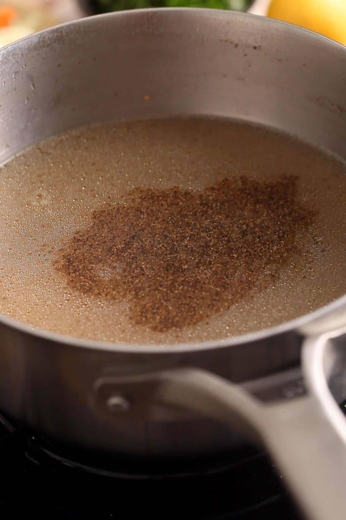 Condiments and spices are added to teh chicken broth.