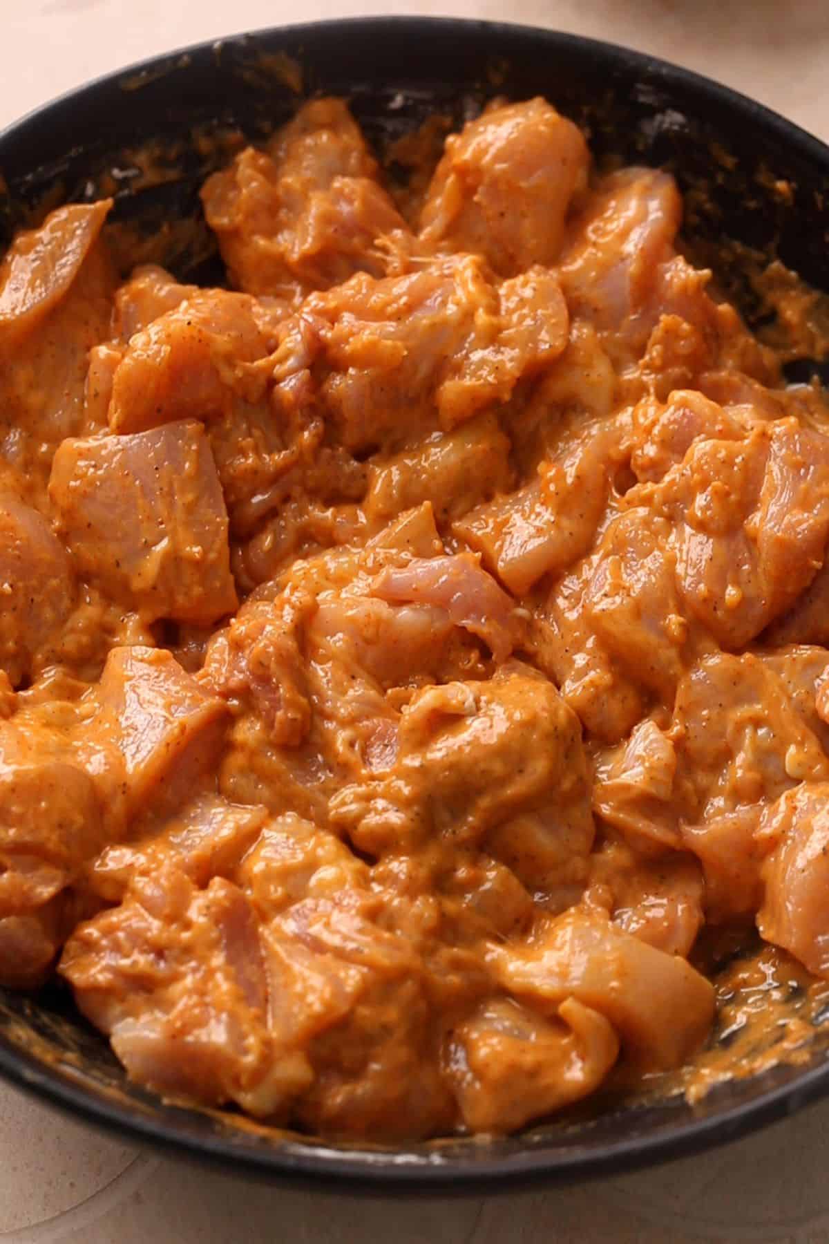 Chicken is coated in marinade and left to marinate.