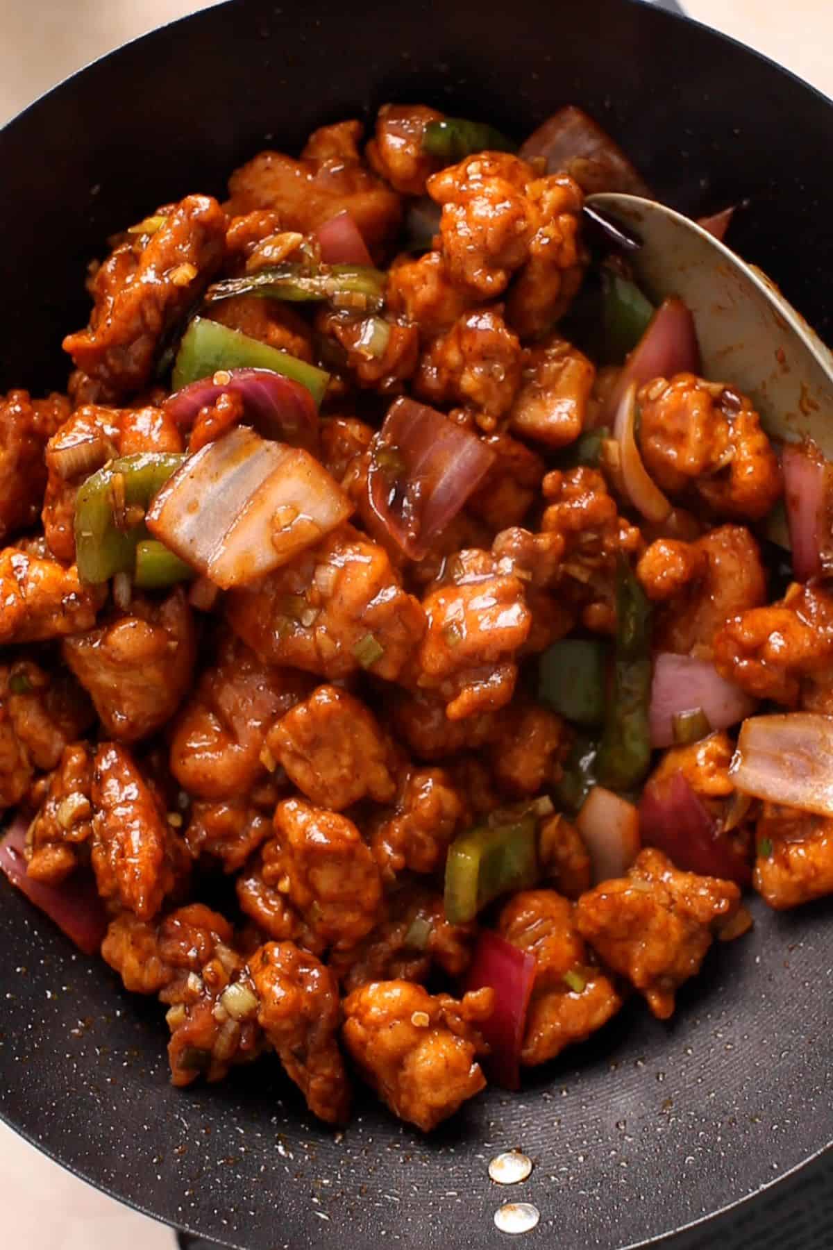 Chilli chicken is stir fried on high heat to create smoky flavors.