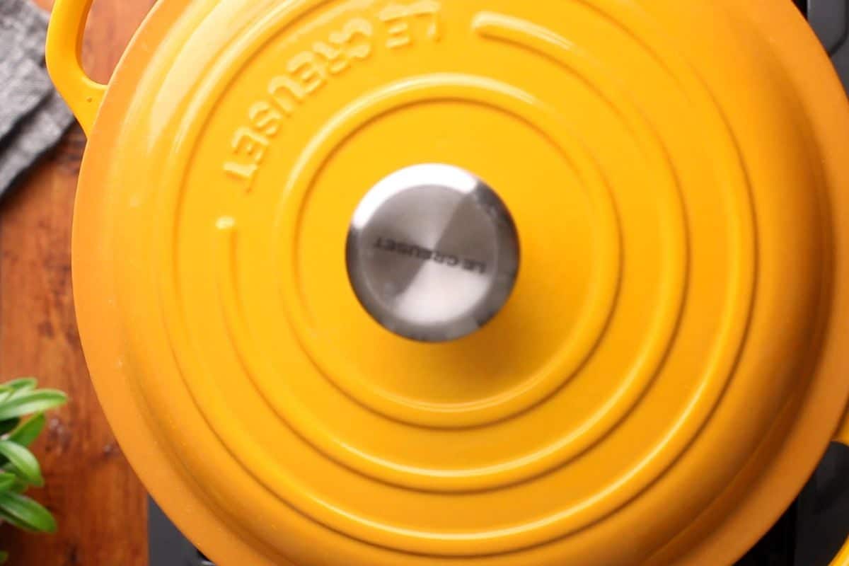 Cooking pot is closed with a lid and left to slow cook.