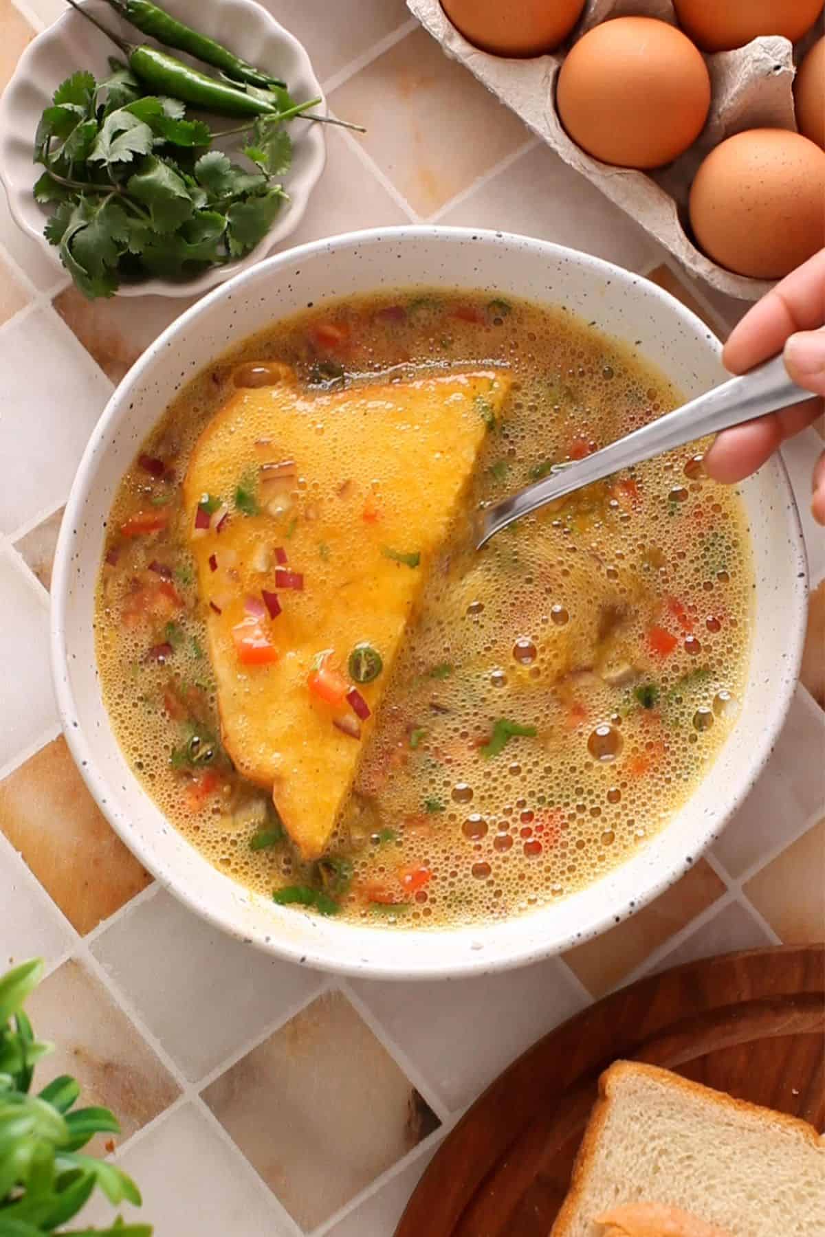 Bread slices are dipped in the egg mixture.