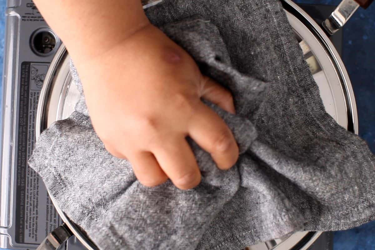 Cooking pot is covered and makhani sauce is left to simmer.