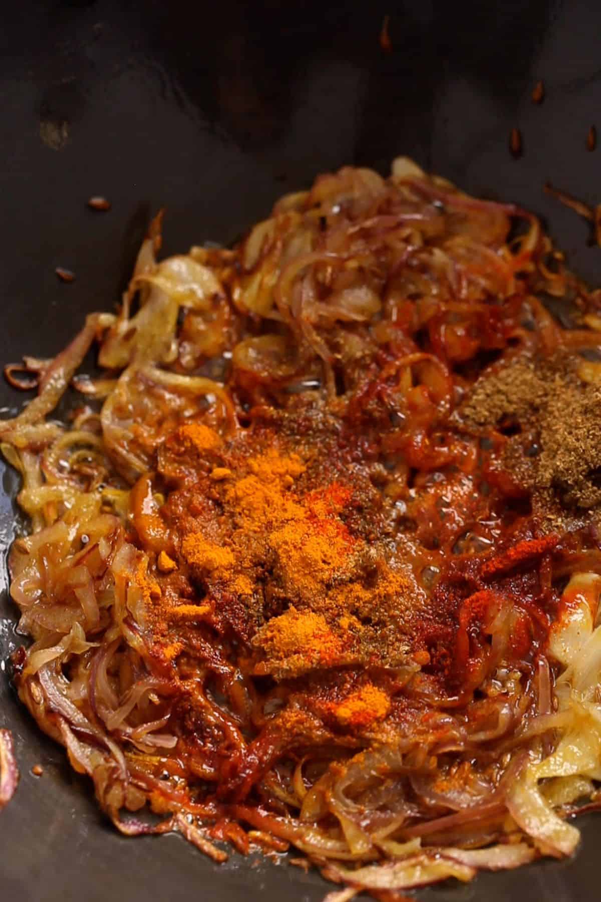 Ground spices are added to the fried onions.