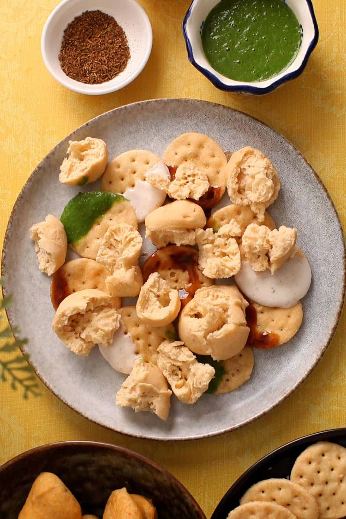 Papdi and bhalla are layered on an ivory plate. 