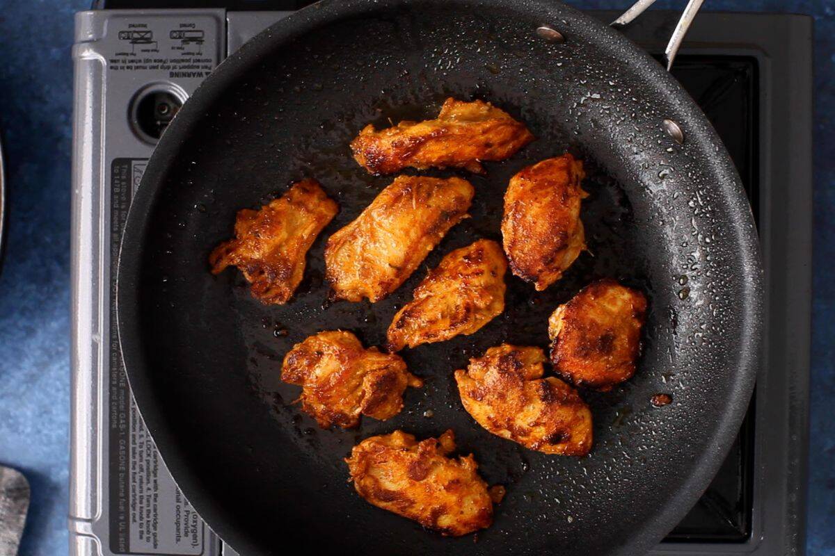 Chicken is flipped and its charred. 