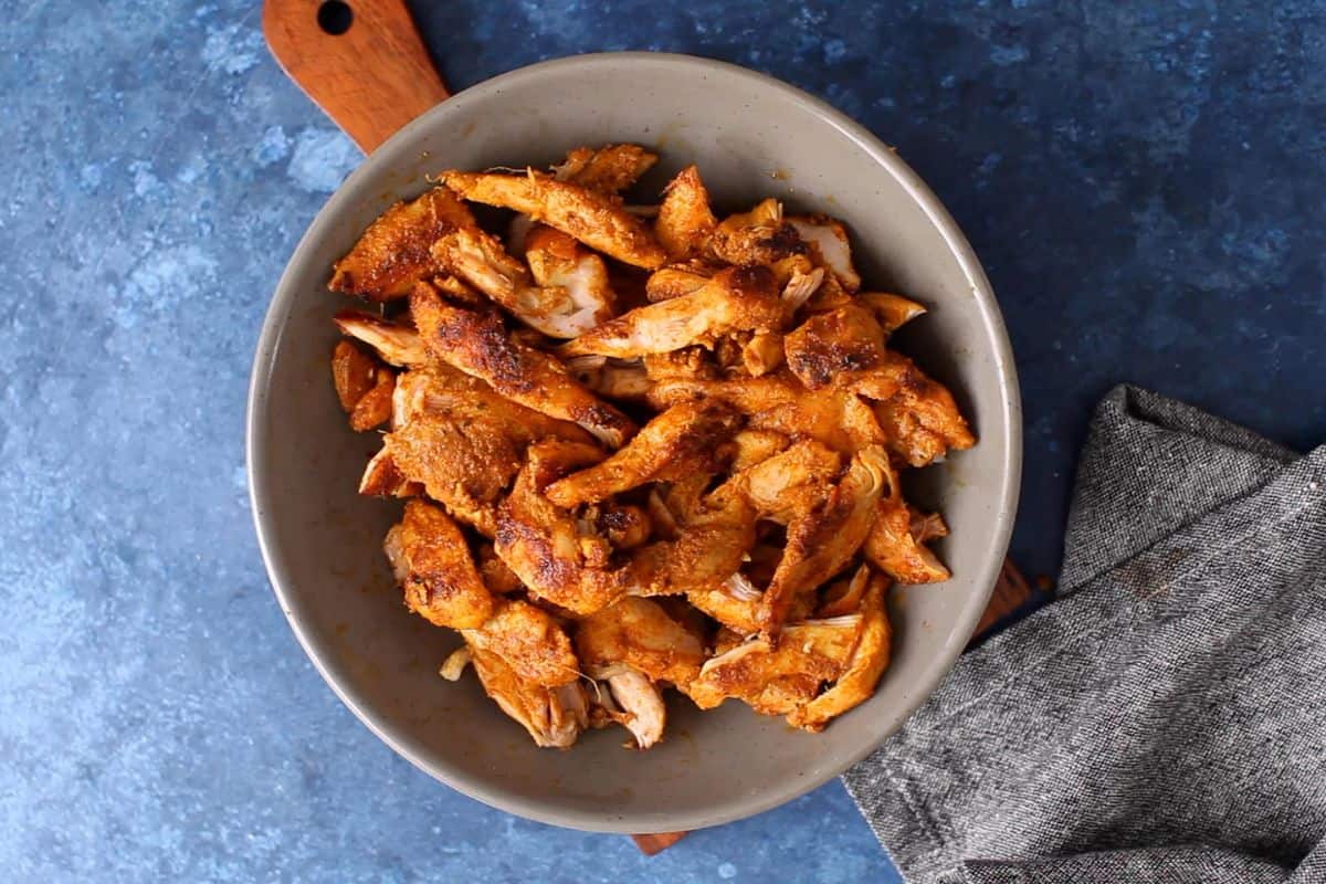 Charred chicken is cut in thin stips. 