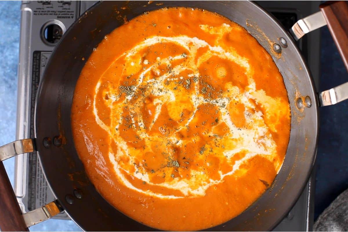 Butter chicken is finished with heavy cream and crushed kasuri methi.
