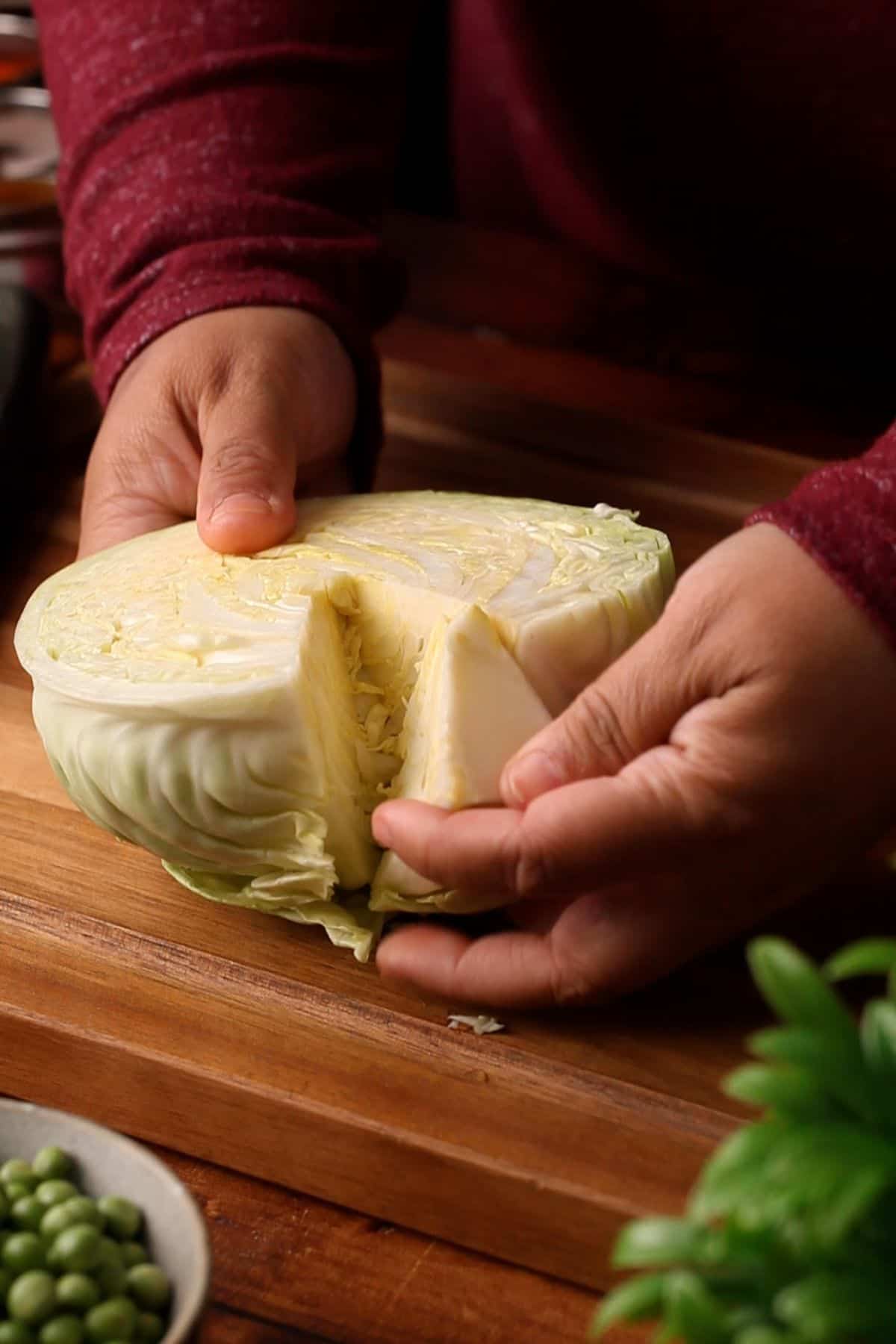 Removing the stem from a cabbage half.