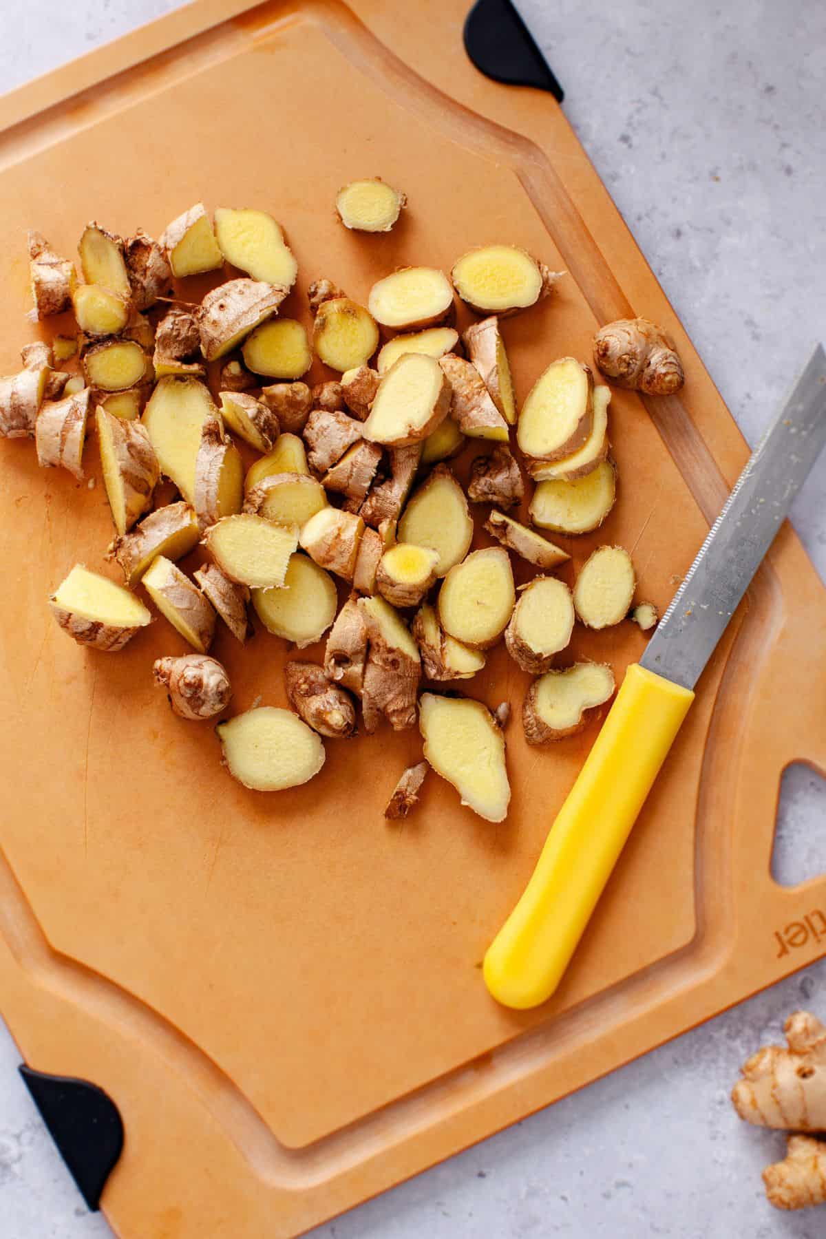 Cut up ginger on cutting board.