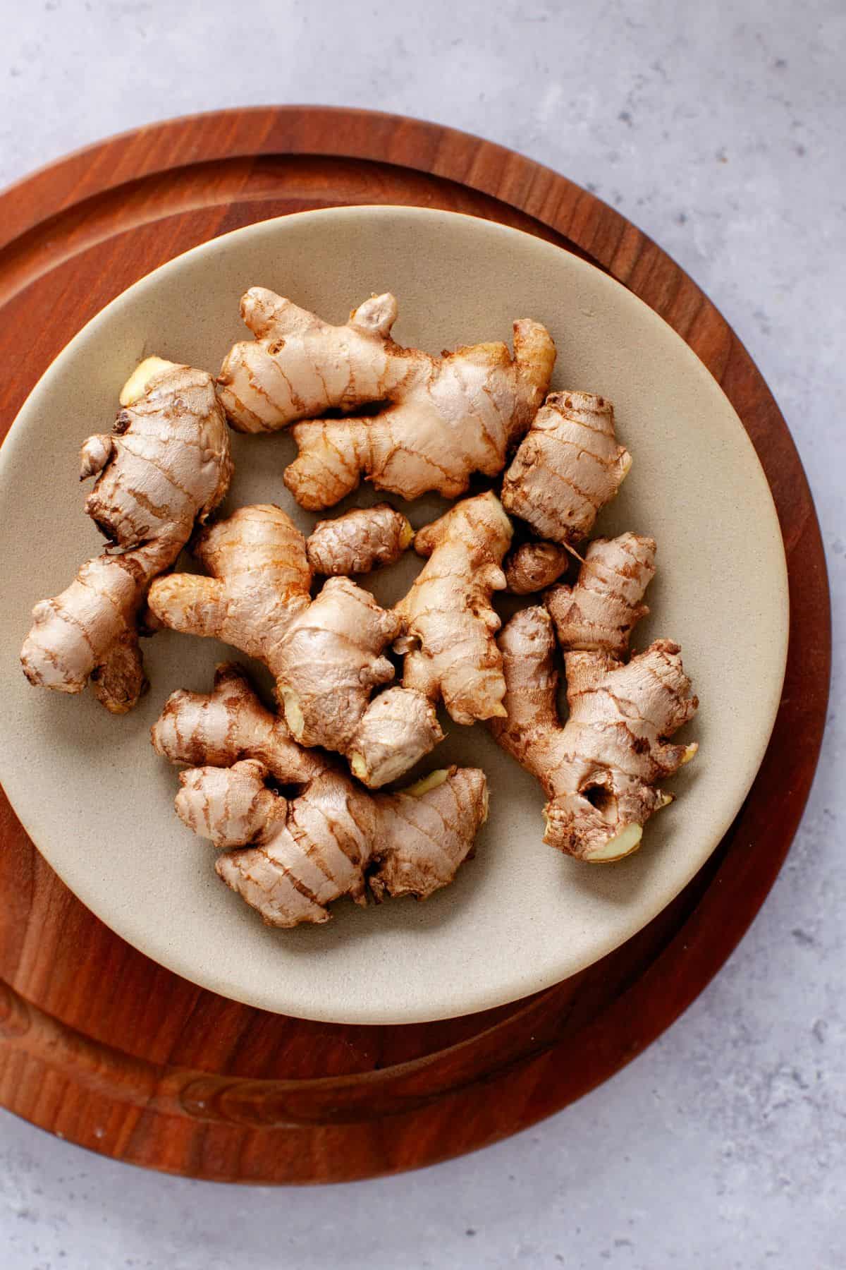 Washed ginger in a mustard plate.