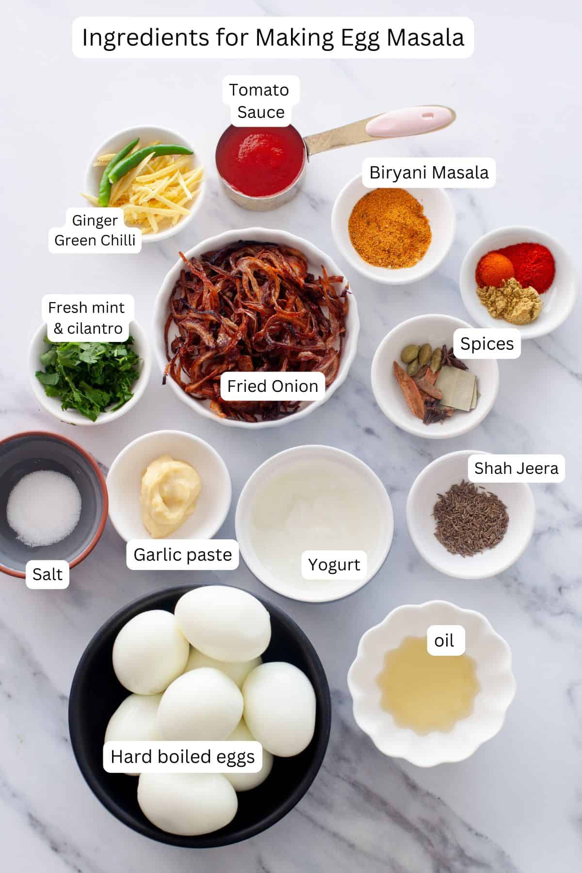 Ingredients needed to make egg masala placed on a white marble board.