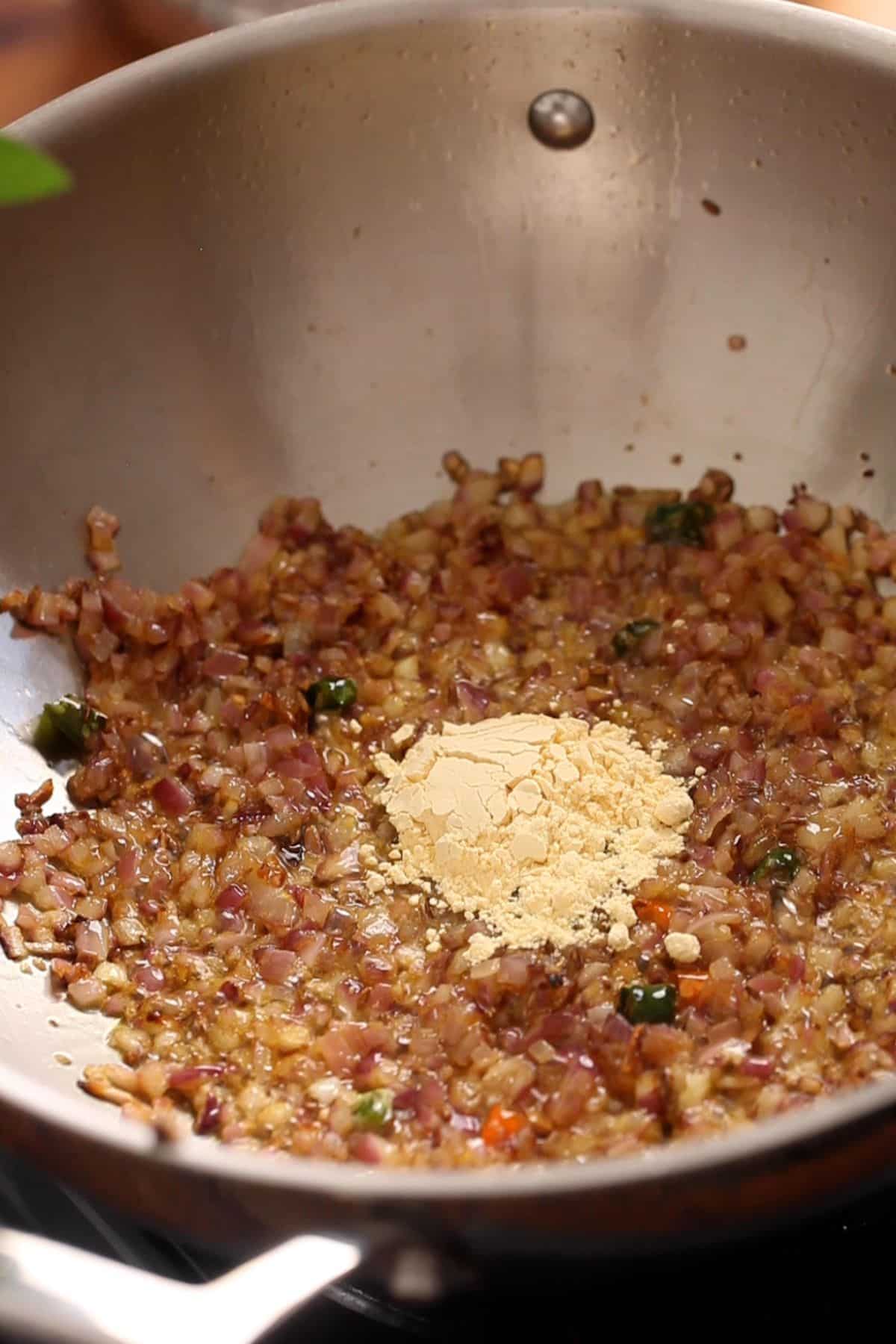 Gram flour is added to browned onions.