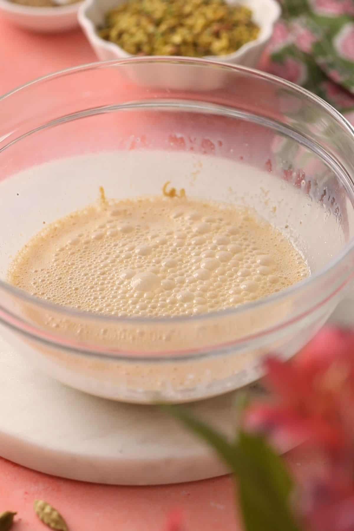 Pistachio cream milk in a glass bowl.