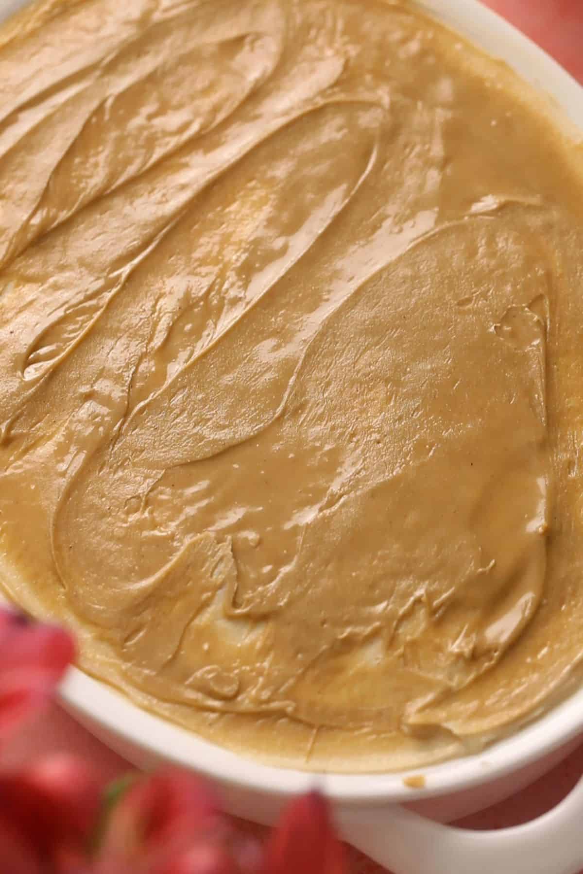 A layer of pistachio cream is spread as the top layer.