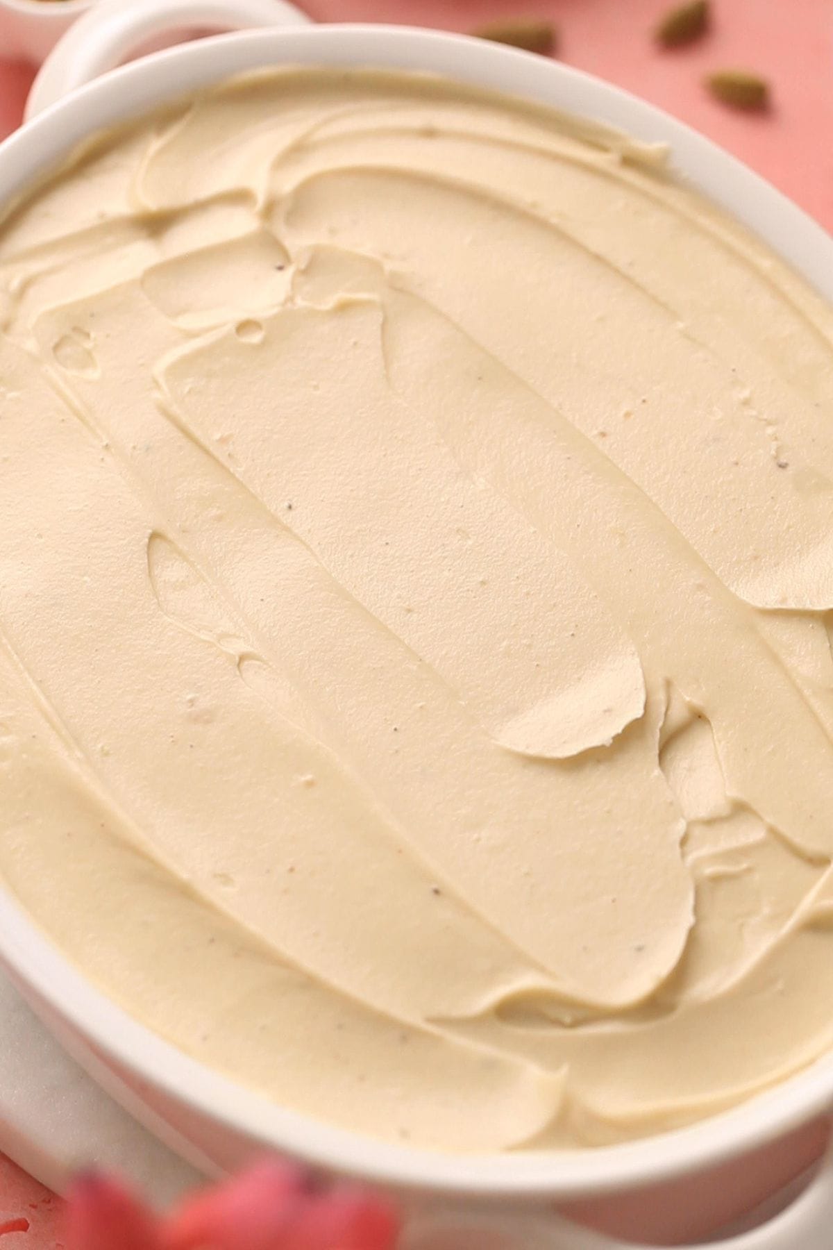 Smoothened top creamy layer of pista tiramisu.