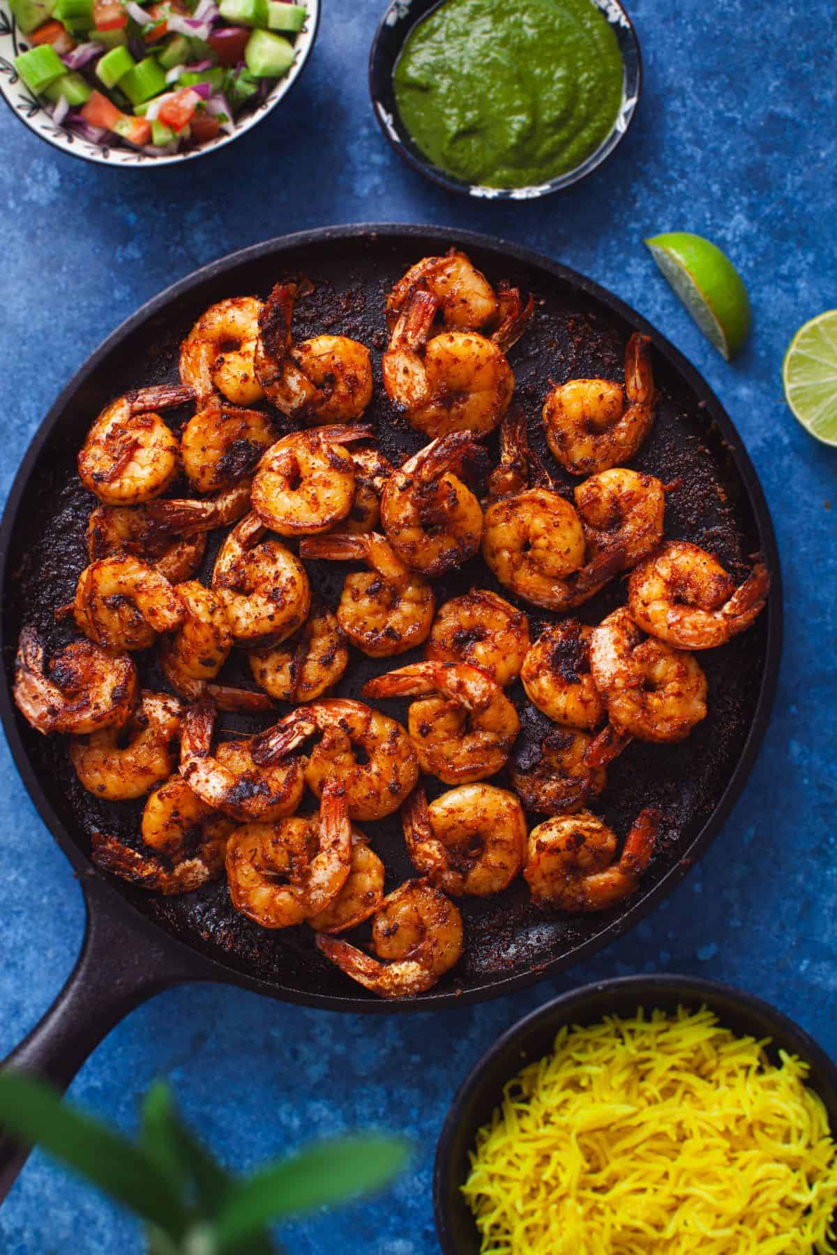 Tandoori shrimp on a cast iron griddle.