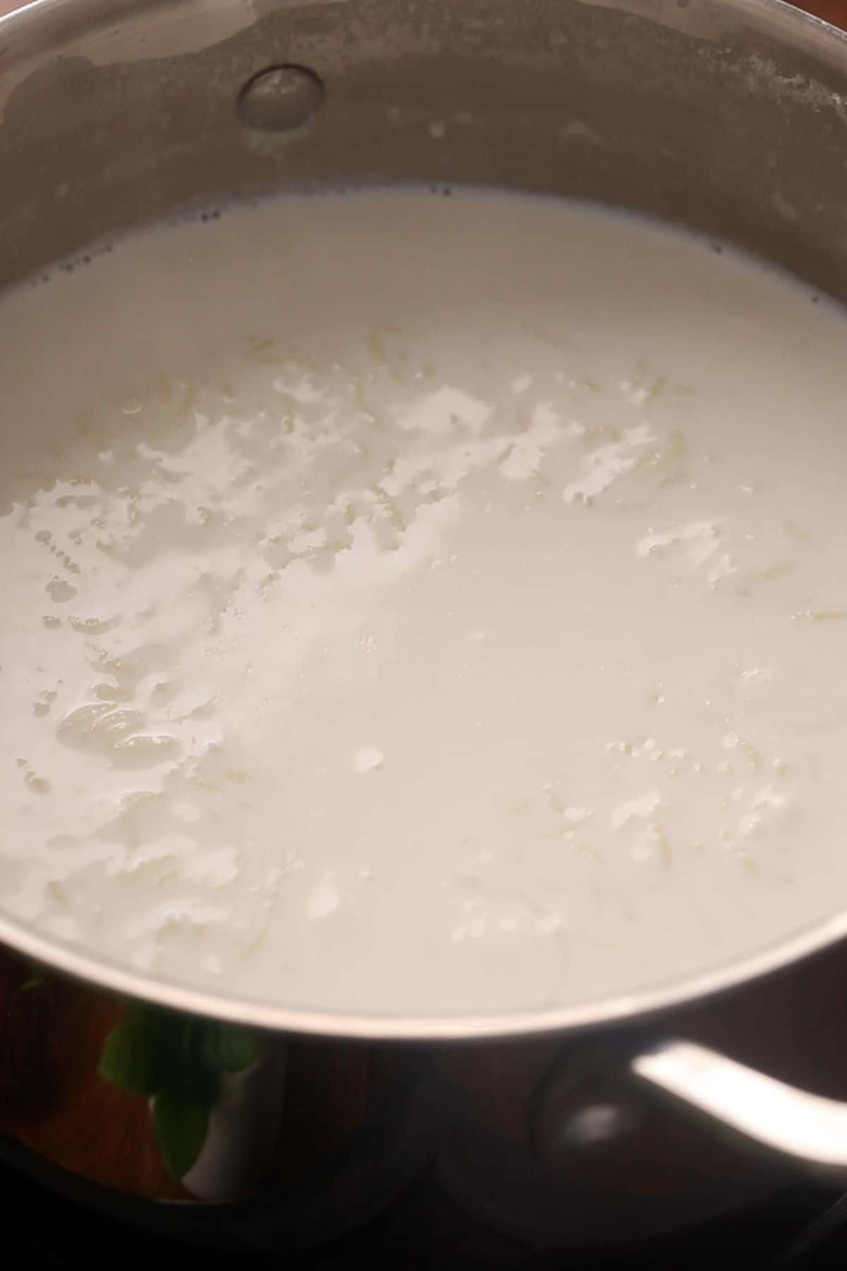 Milk thickens as the rice cooks and softens.