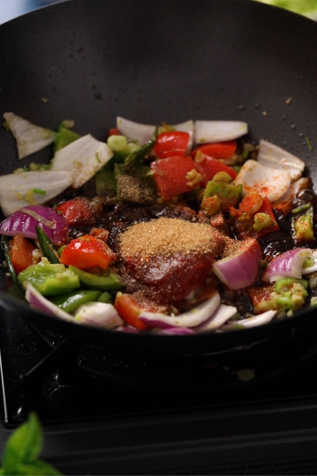 Condiments are added to the wok to make the chilli sauce.