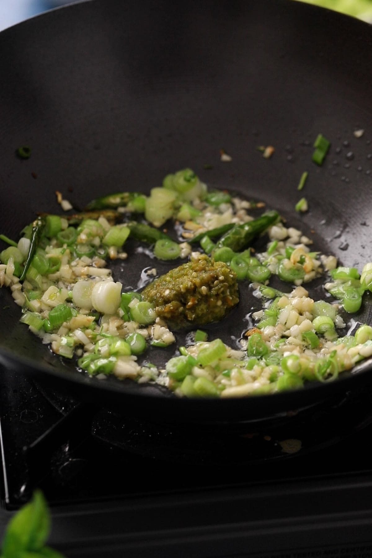 Stir frying aromatics in a wok.