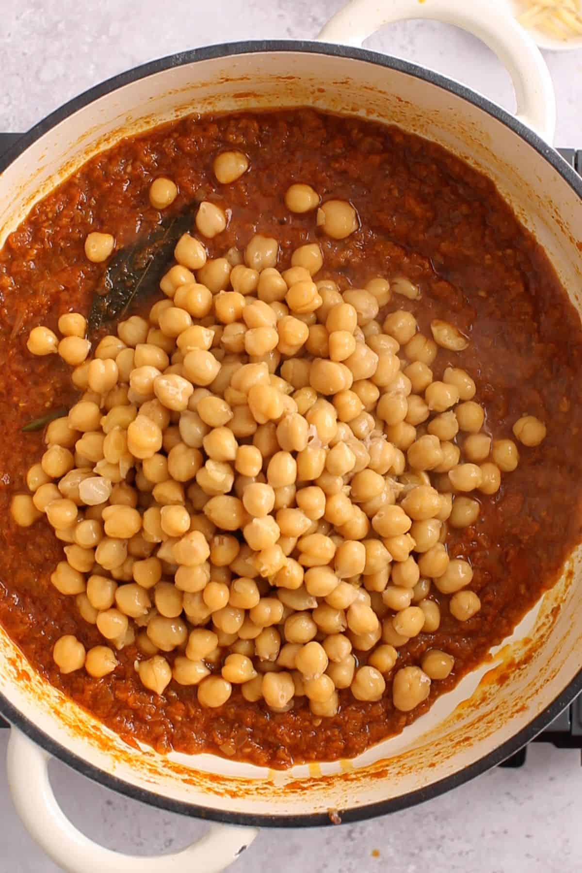 Boiled chickpeas are added to the tomato masala.