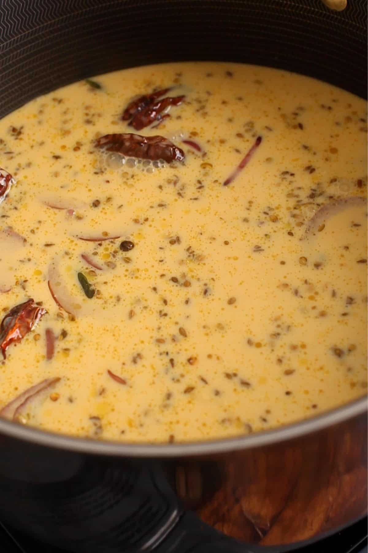 Yogurt and besan mixture is added to the spices and aromatics.