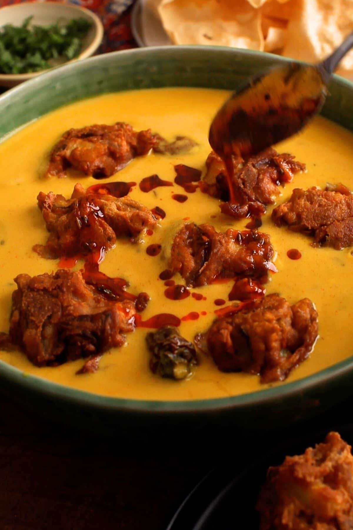 Final ghee tadka is poured on top of kadhi.