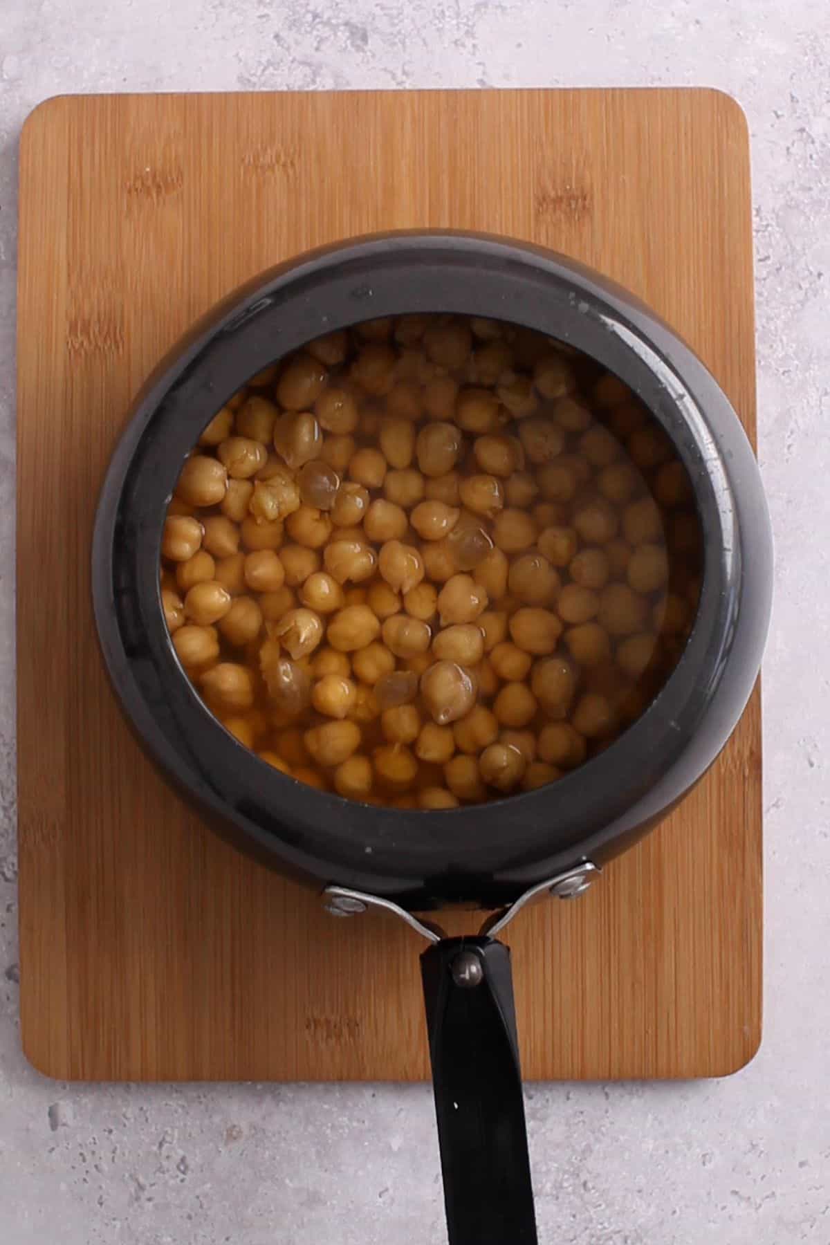 Boiled chickpeas in a black pressure cooker.