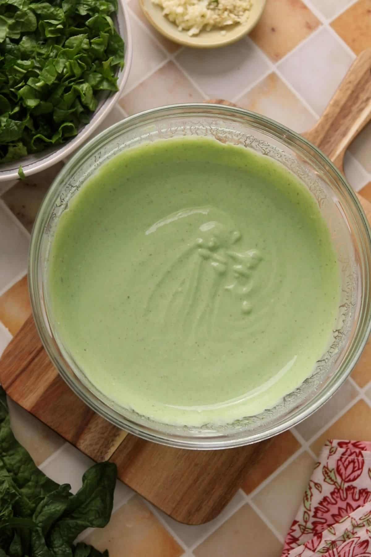 Green spinach yogurt in a glass bowl.