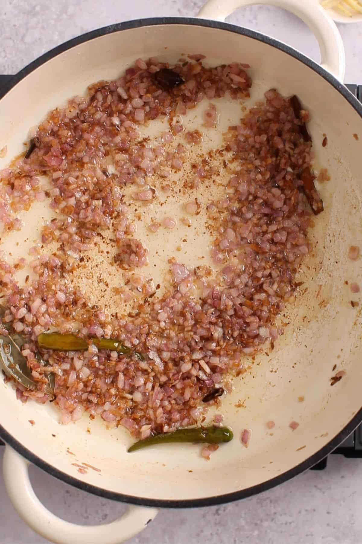 Golden fried onions with spices and aromatics.