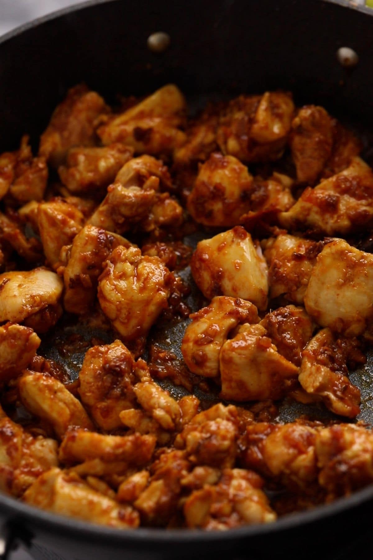 Stir fried chicken is browned and the juices are dried up.
