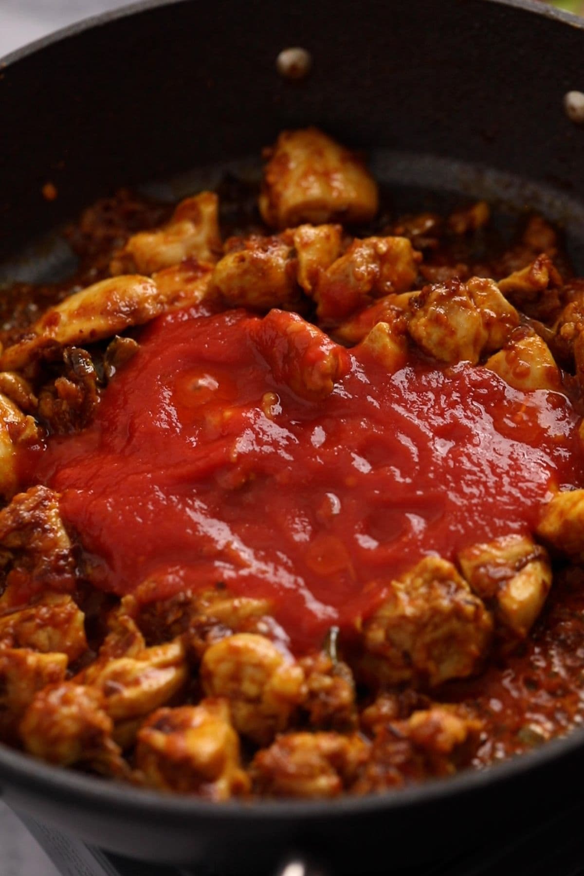 Tomato sauce and sriracha are added to the jalfrezi.