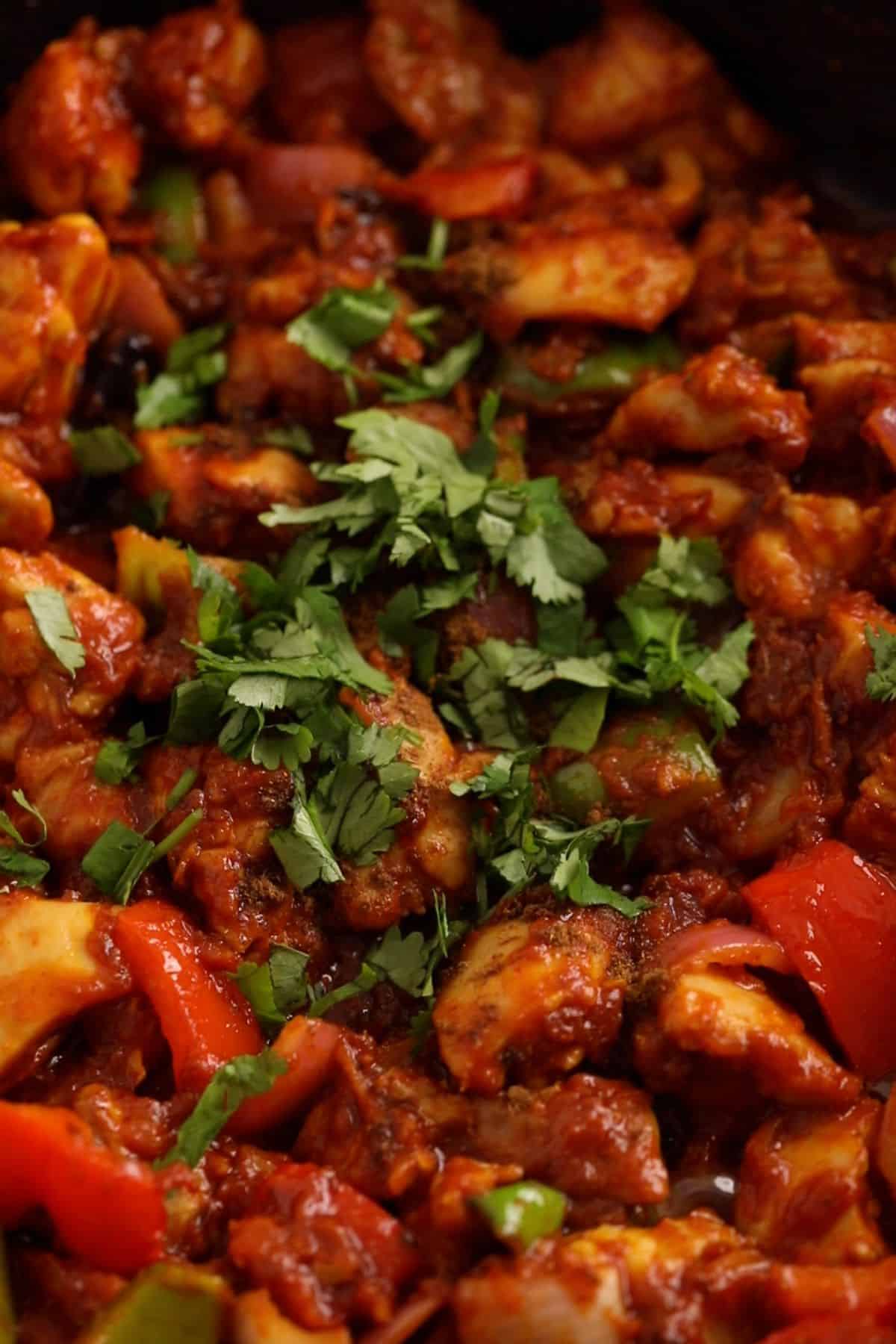 Chicken jalfrezi is garnished at cilantro and ready to serve.