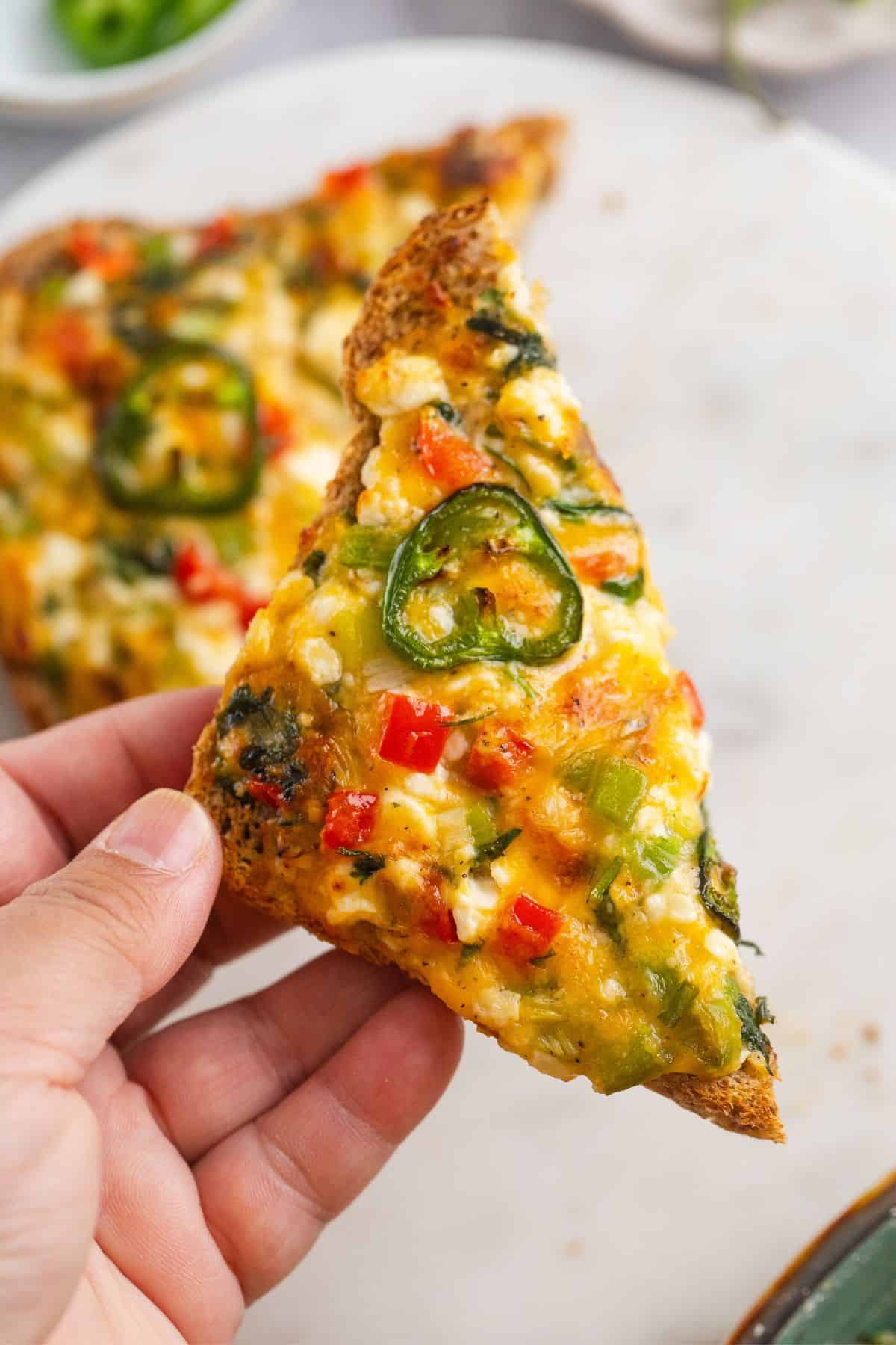 Cottage cheese chilli toast half picked in hand.