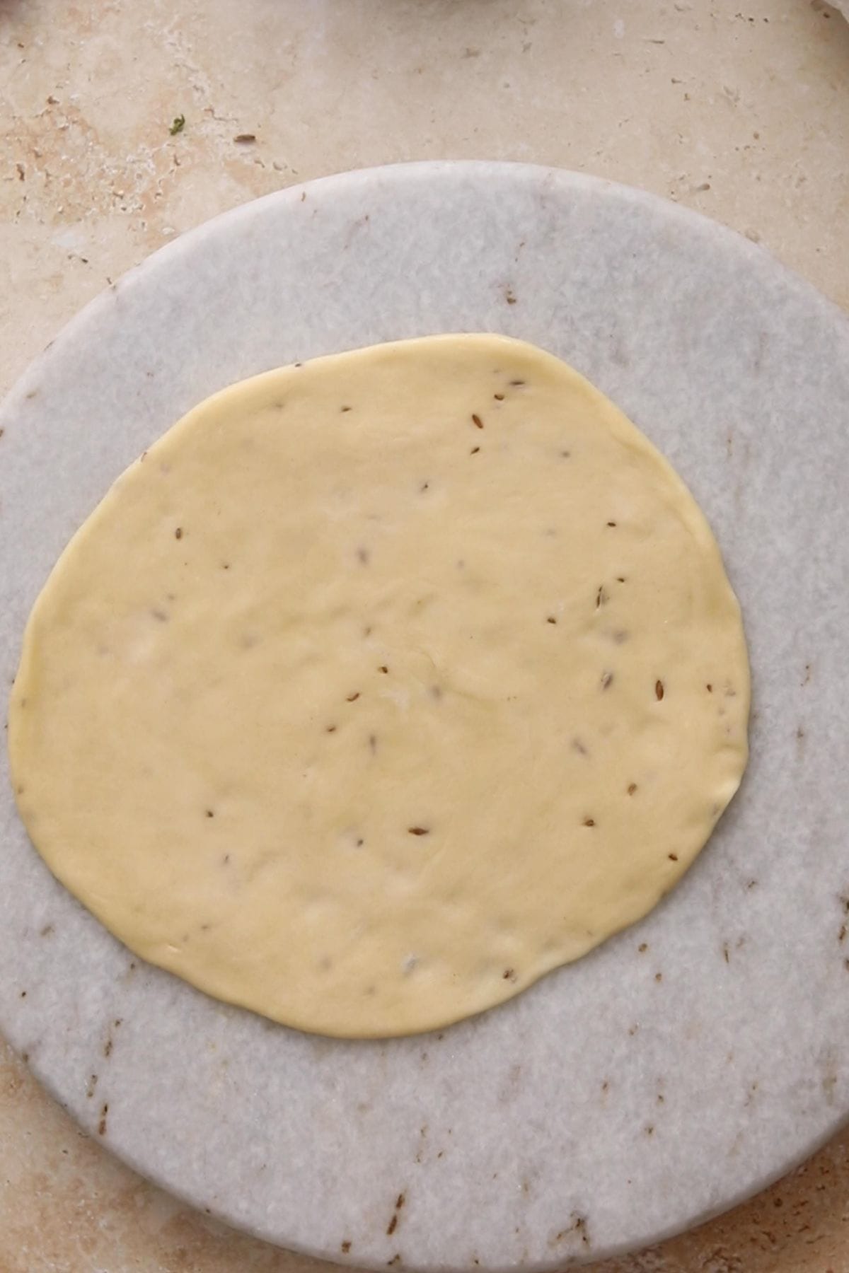 Dough is rolled into a circle.