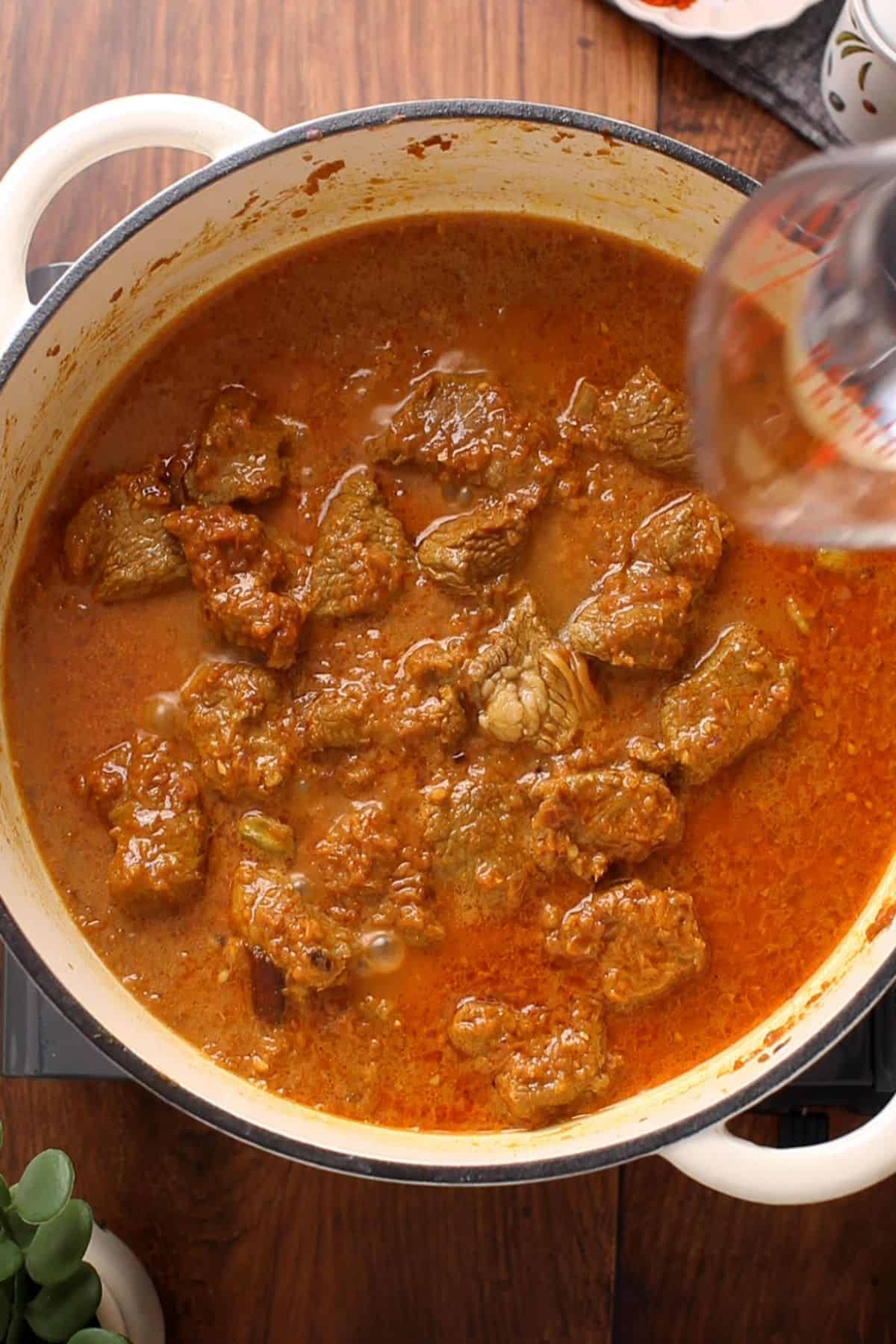 Hot water is added to the lamb.