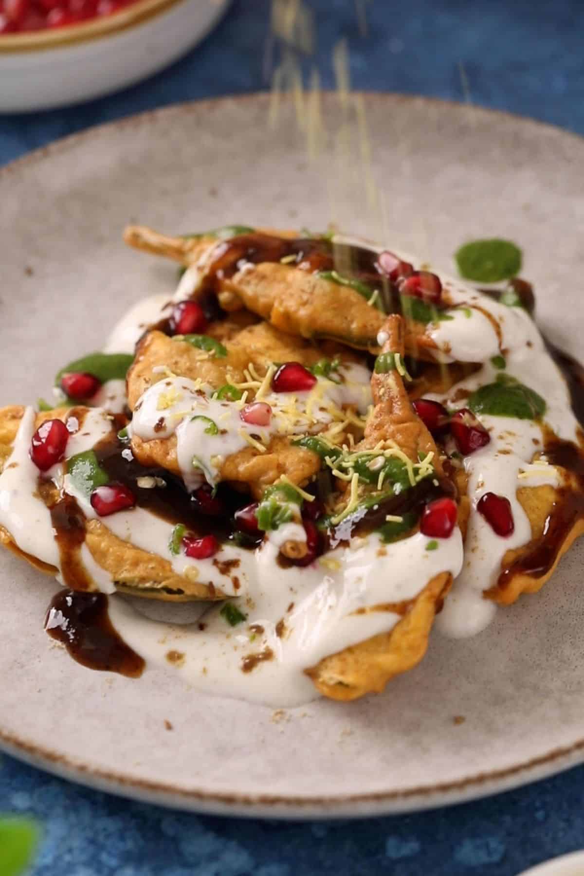 Chutneys and spices are added to palak patta chaat.