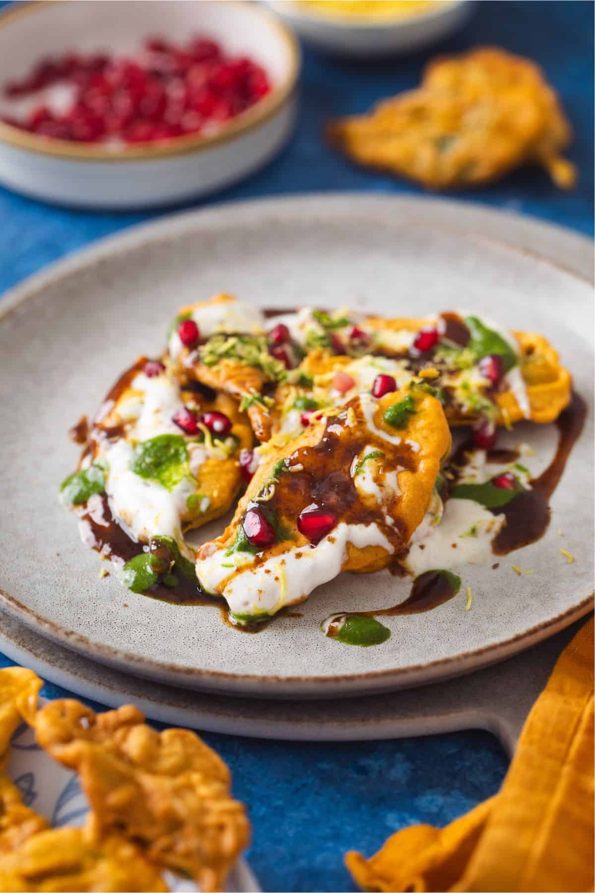 Palak patta chaat served in a white ceramic plate.